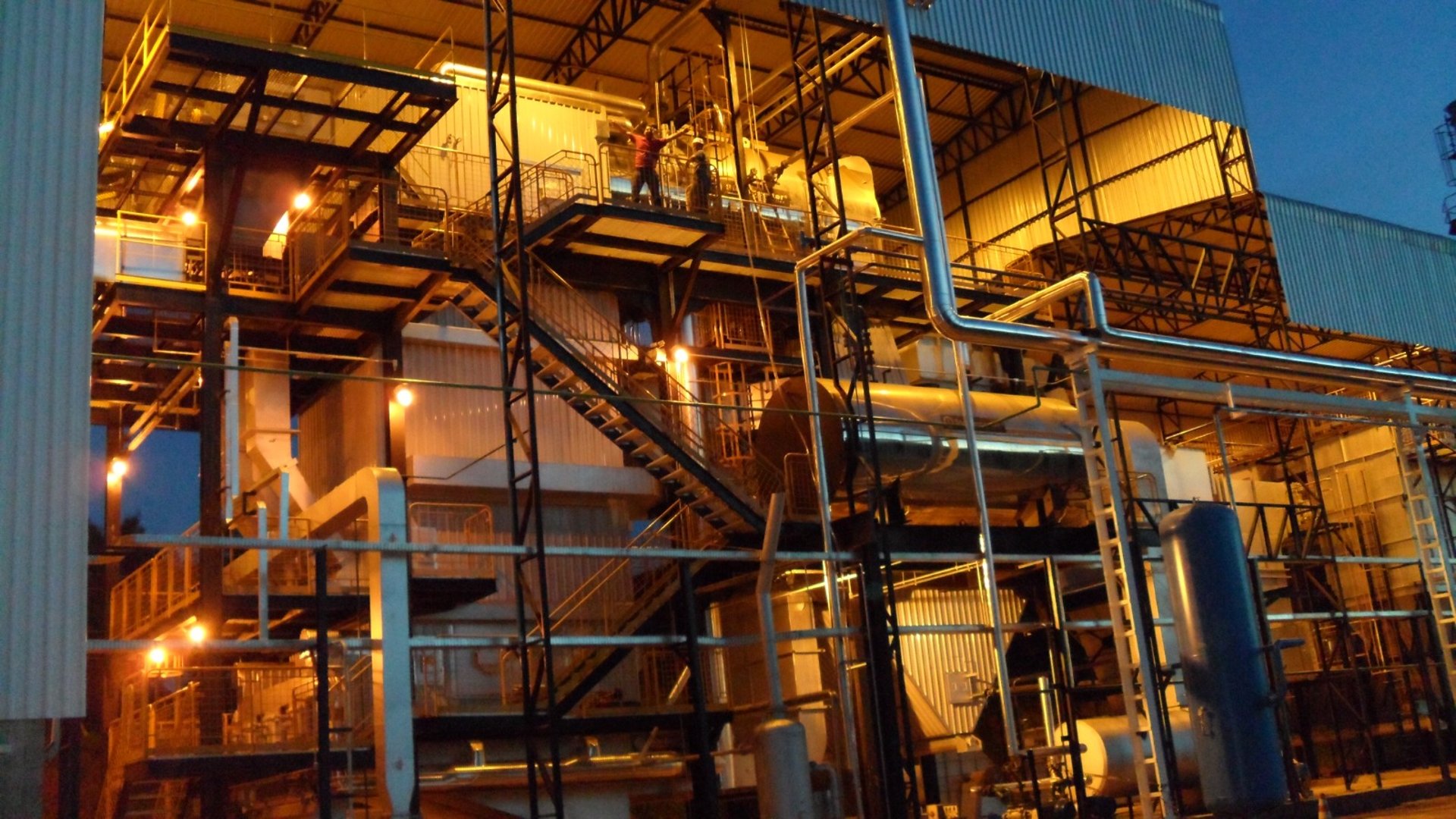 an abstract photo of a curved building with a blue sky in the background