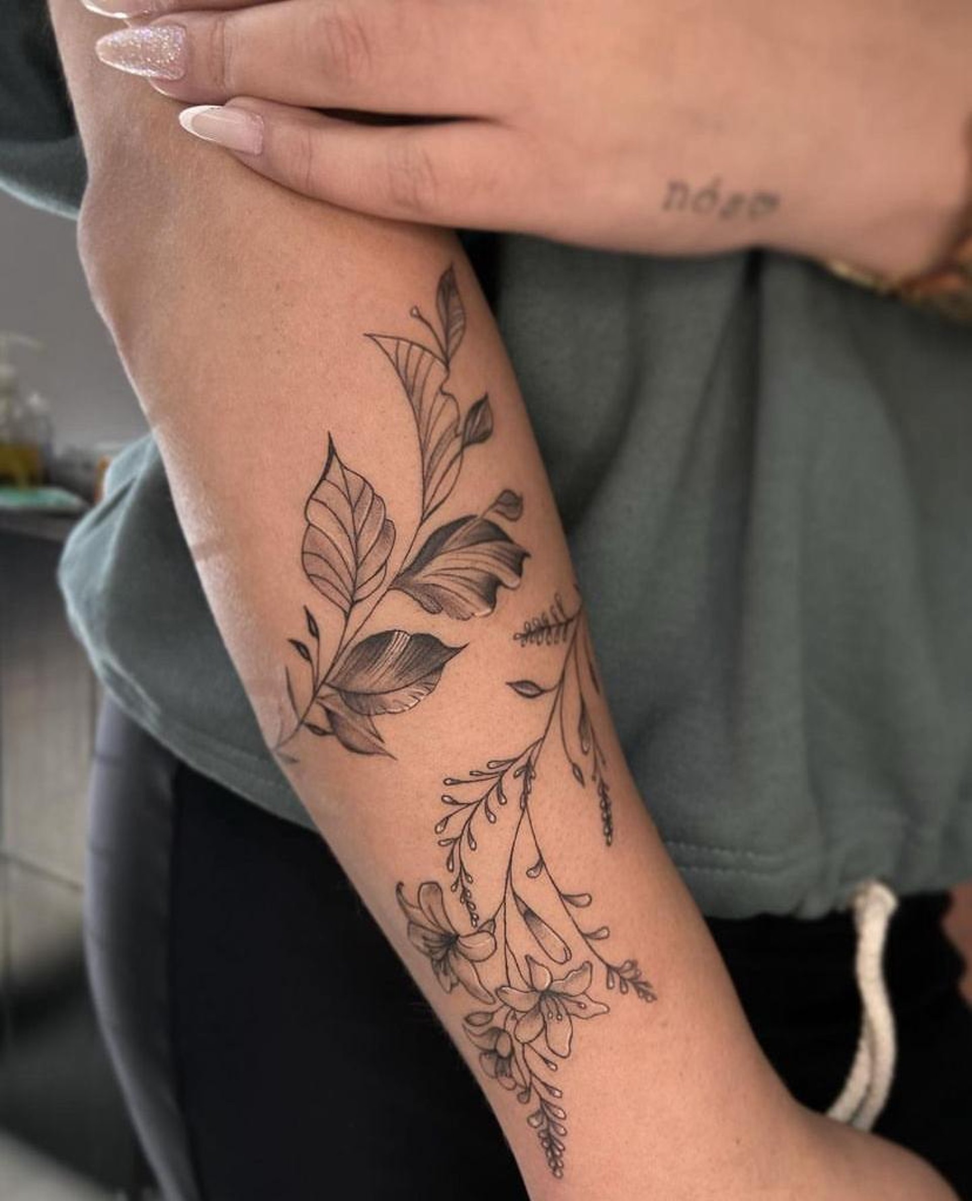a woman with a flower tattoo on her arm