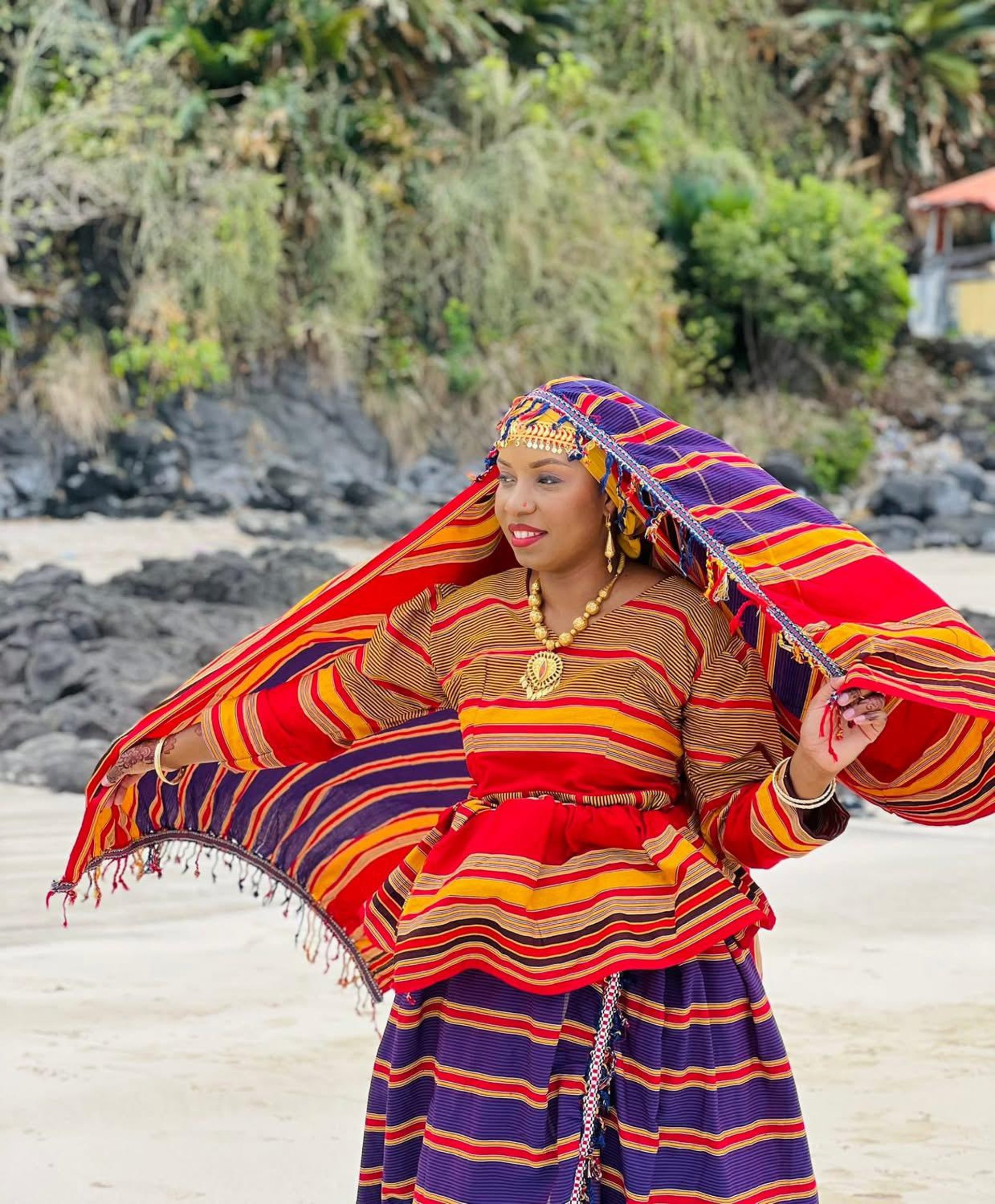woman wearing yellow long-sleeved dress under white clouds and blue sky during daytime