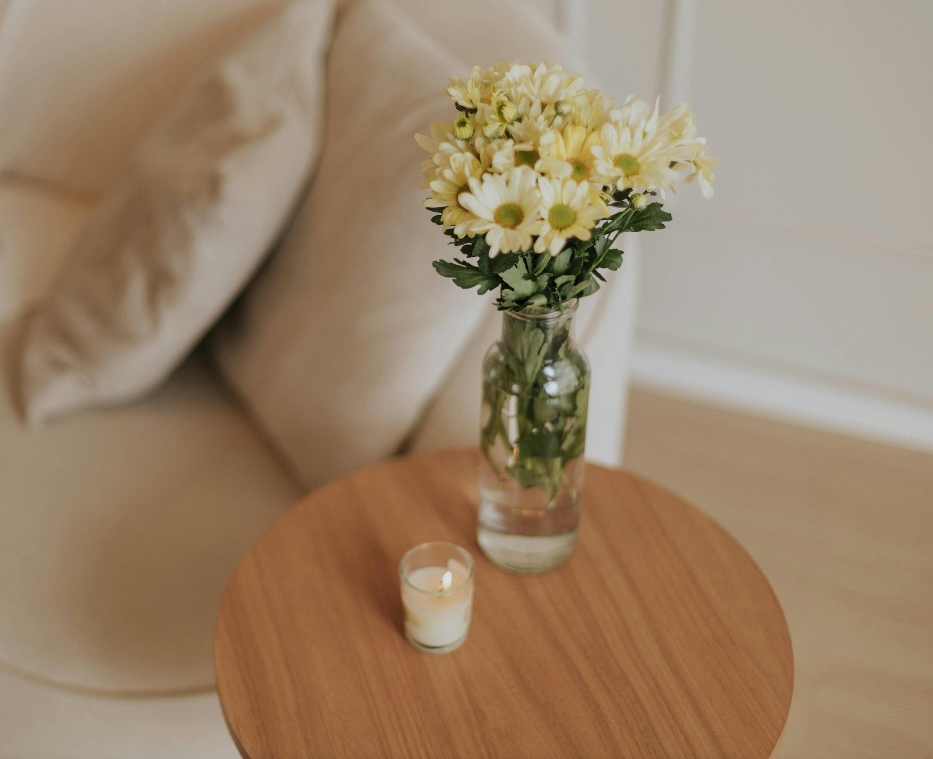a white couch sitting in a living room next to a window