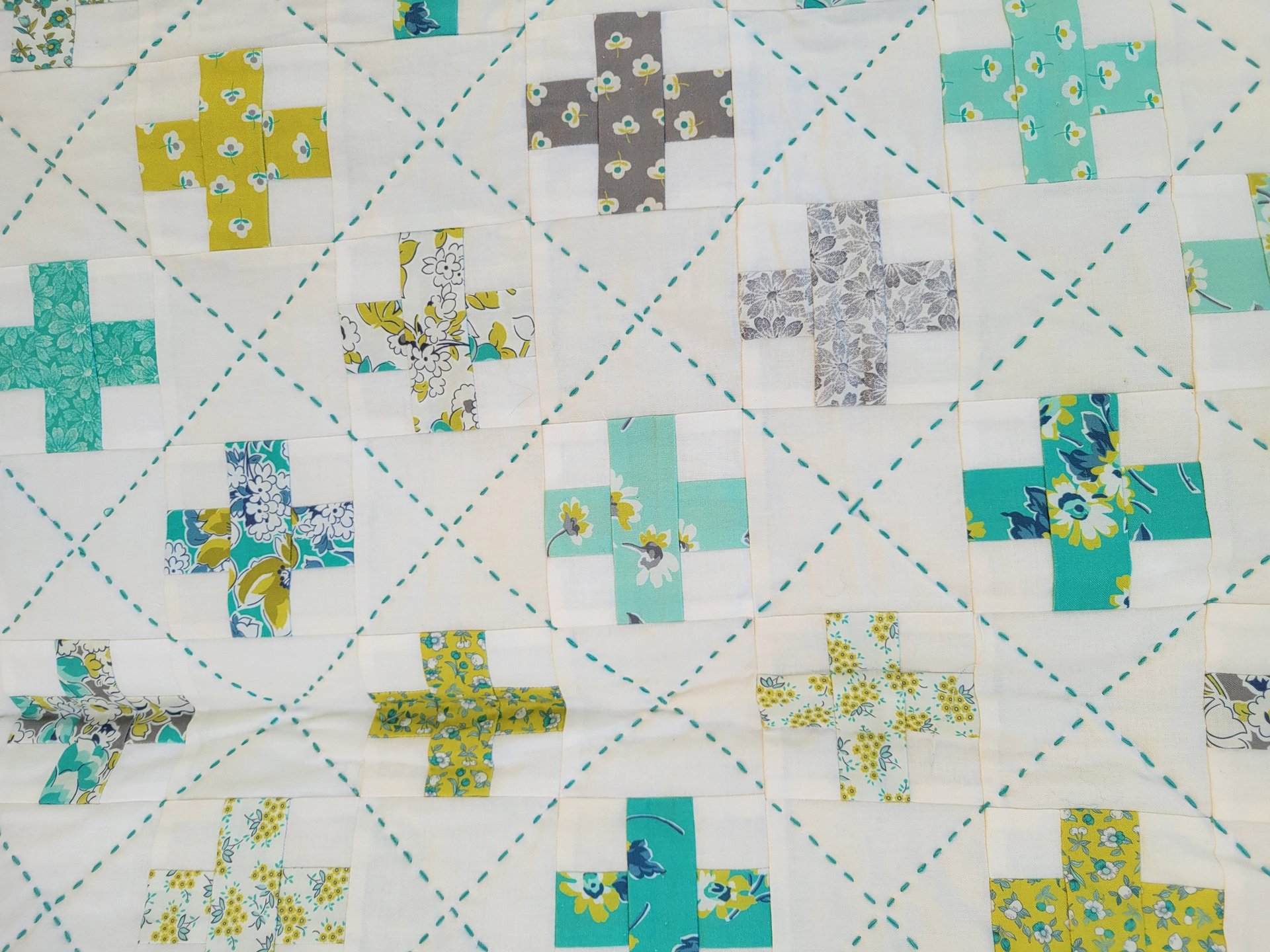 a close up of a quilt with many different colors