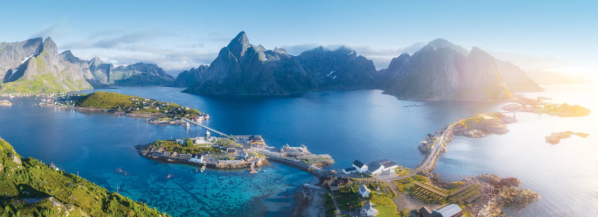 aerial view of green and brown mountain beside body of water during daytime