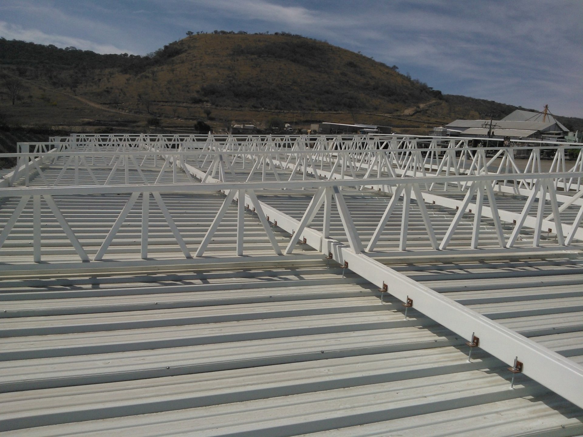 woman wearing yellow long-sleeved dress under white clouds and blue sky during daytime