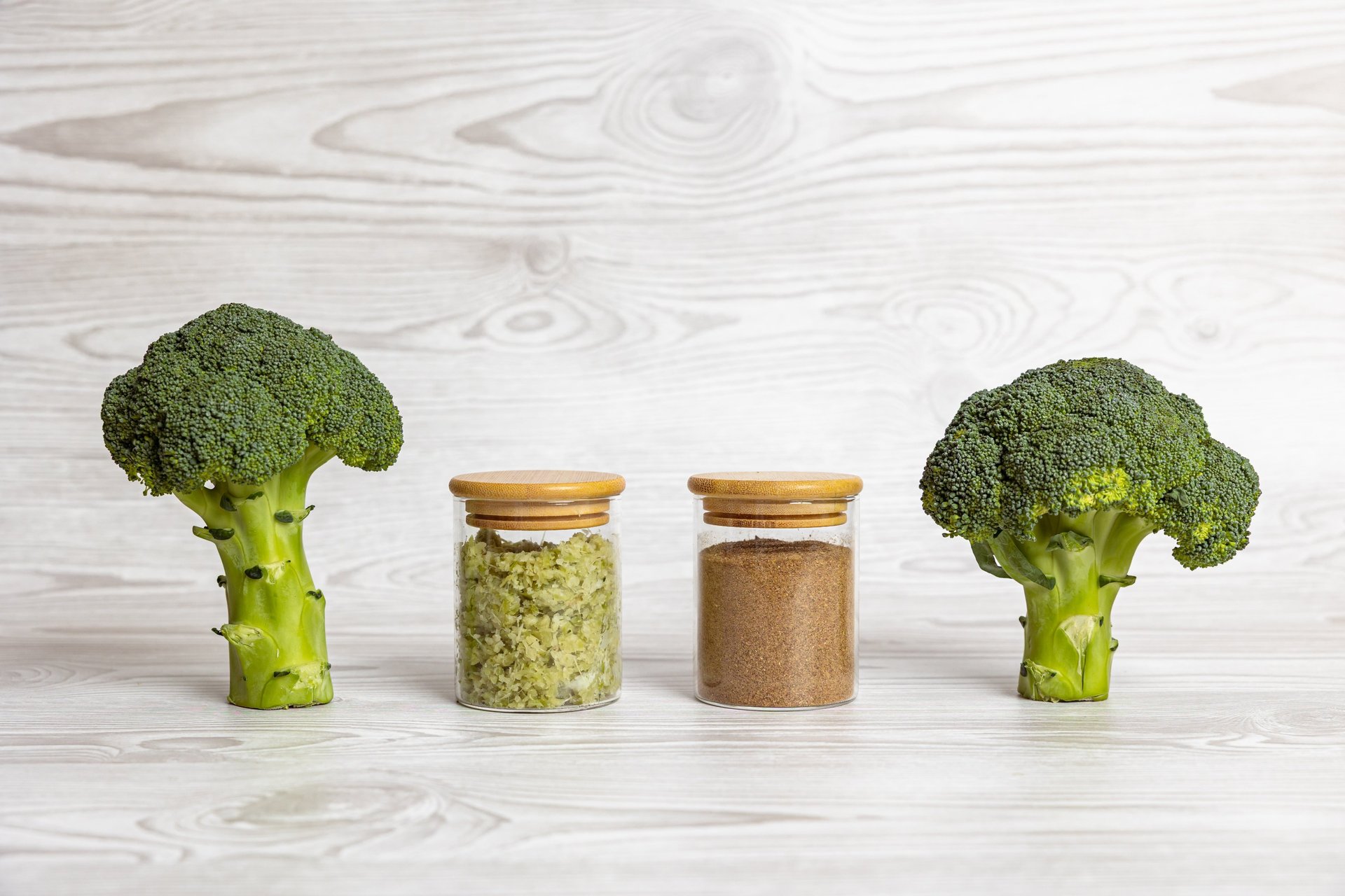 Broccoli head with stems displayed around it