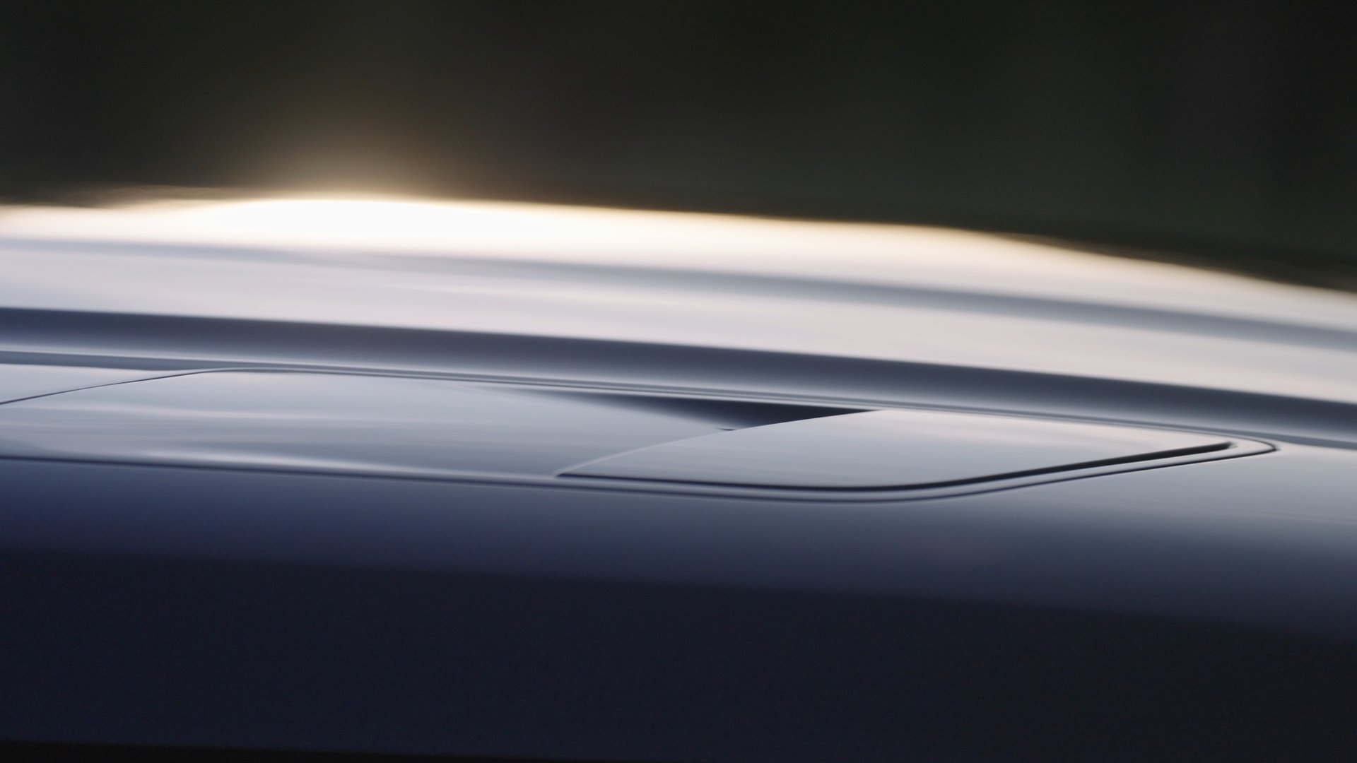an abstract photo of a curved building with a blue sky in the background