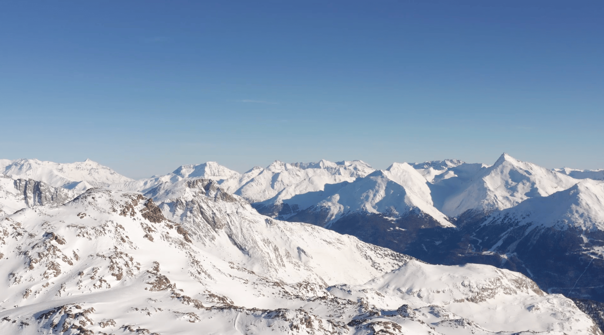 an abstract photo of a curved building with a blue sky in the background