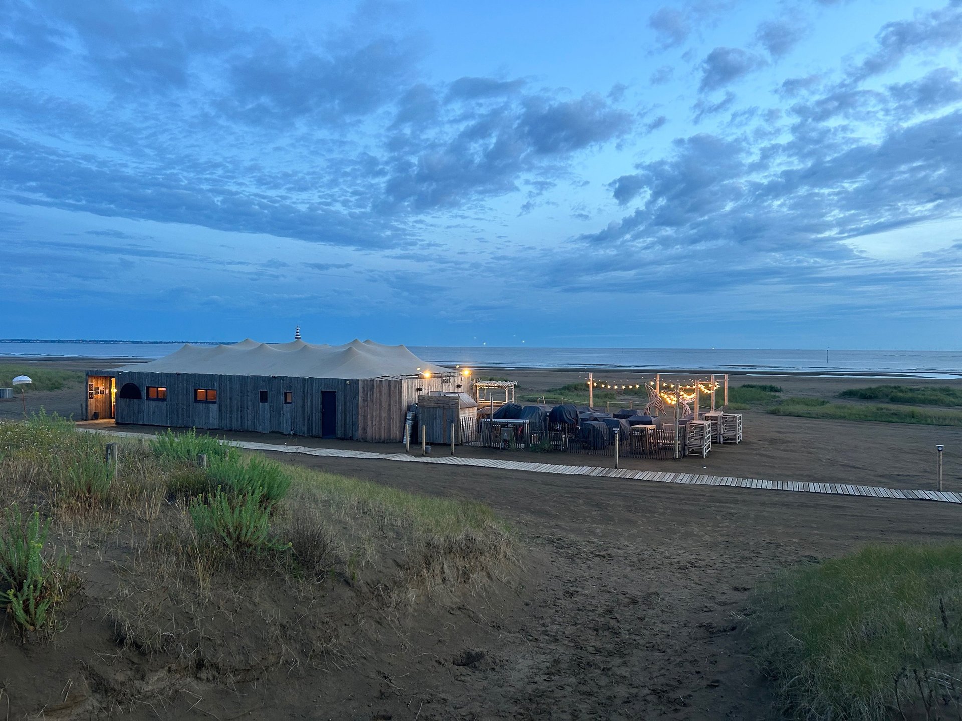 an abstract photo of a curved building with a blue sky in the background