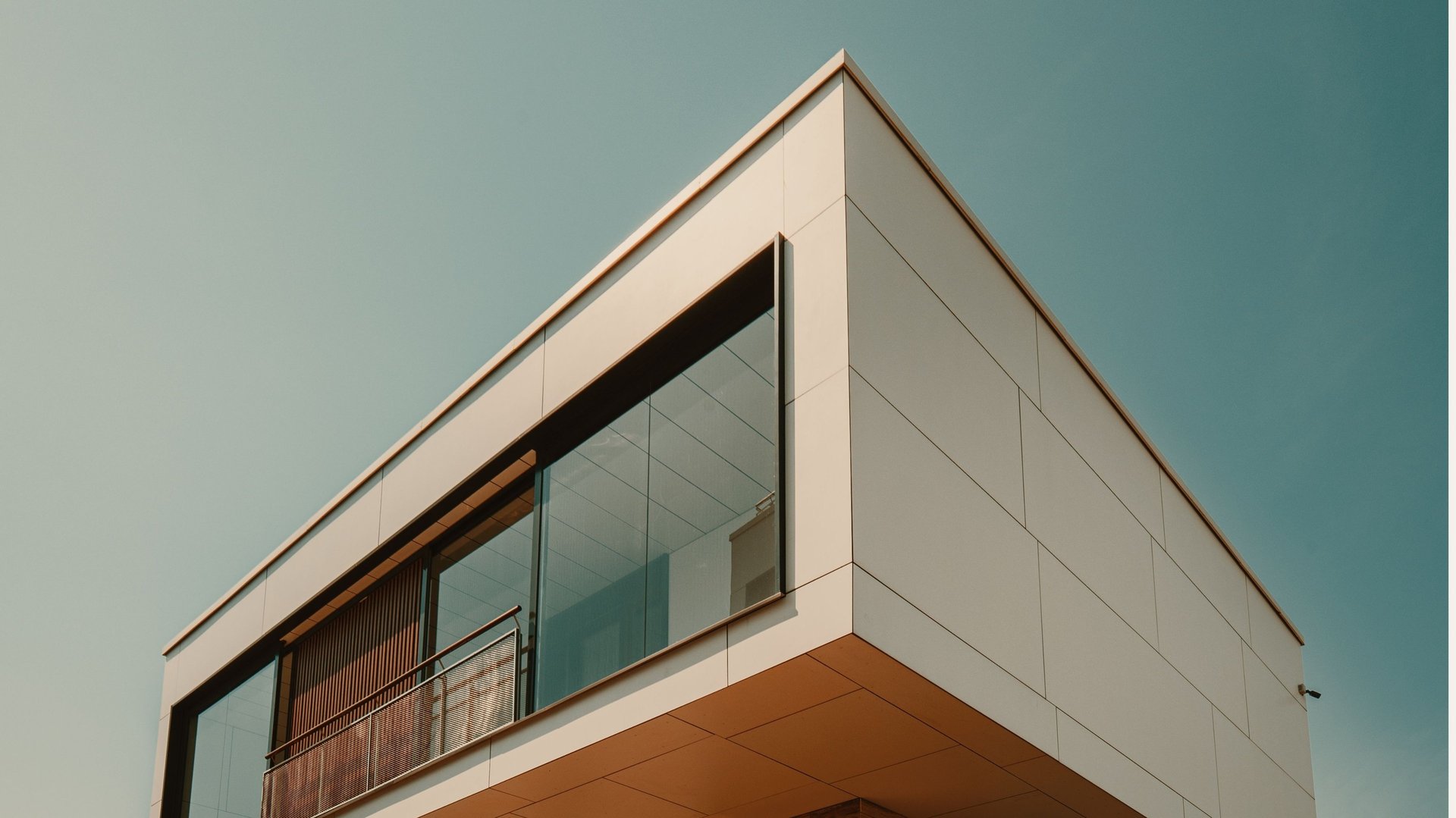an abstract photo of a curved building with a blue sky in the background