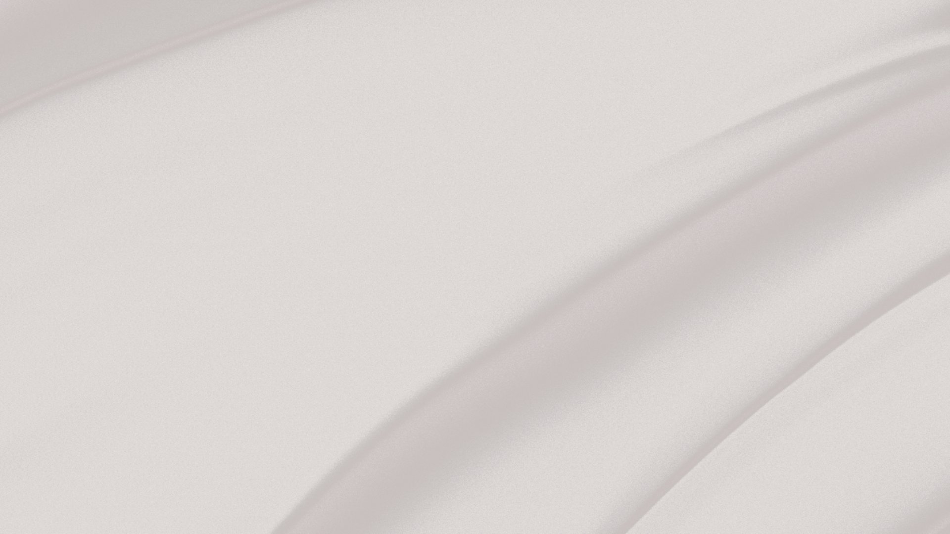 a pink wall with a black and white cat sitting on top of it