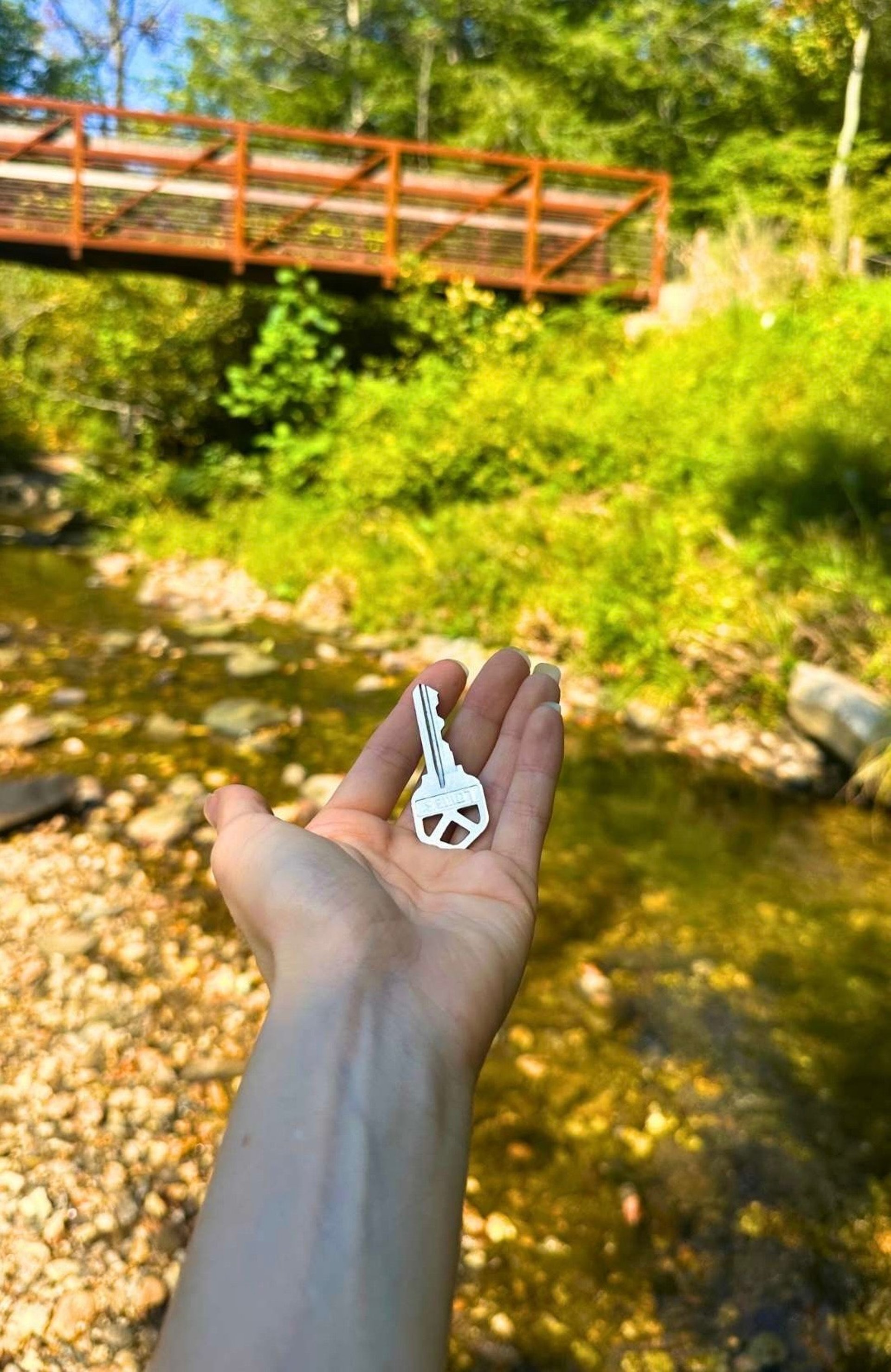 Blue work van with Asheville Locksmith logo driving through West Asheville