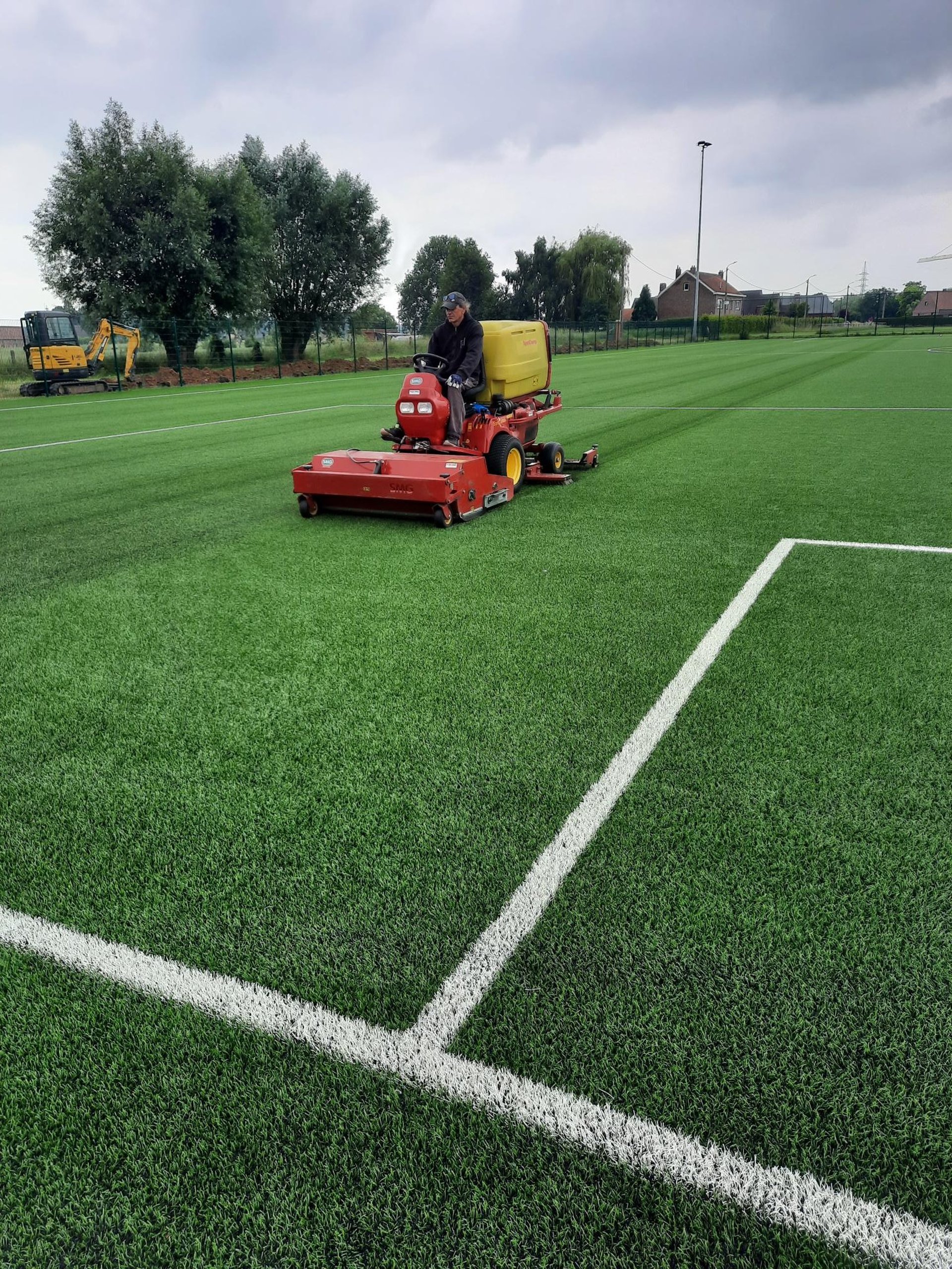 Close-up of a white line on green grass in a soccer field