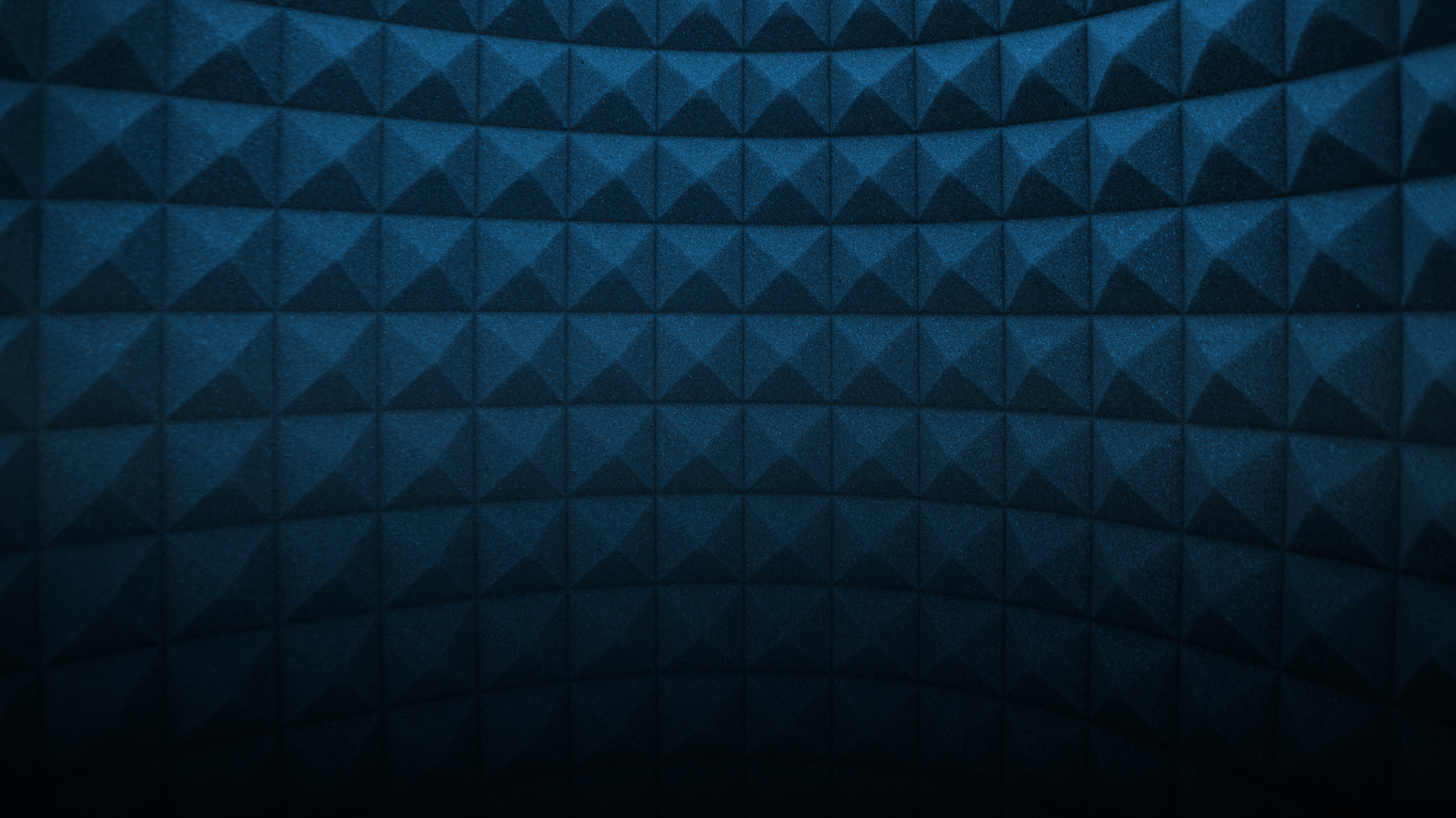 an abstract photo of a curved building with a blue sky in the background