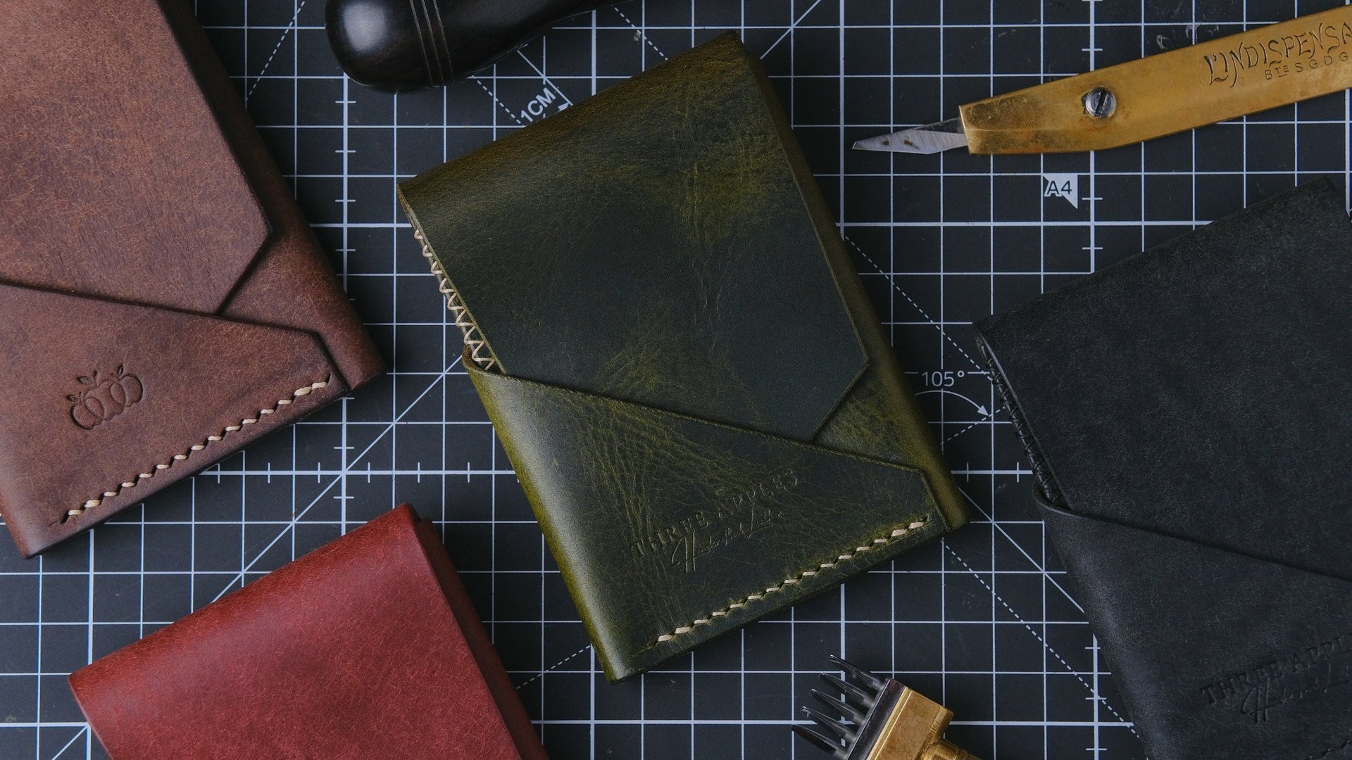 a leather wallet, a comb, thread, and scissors on a table