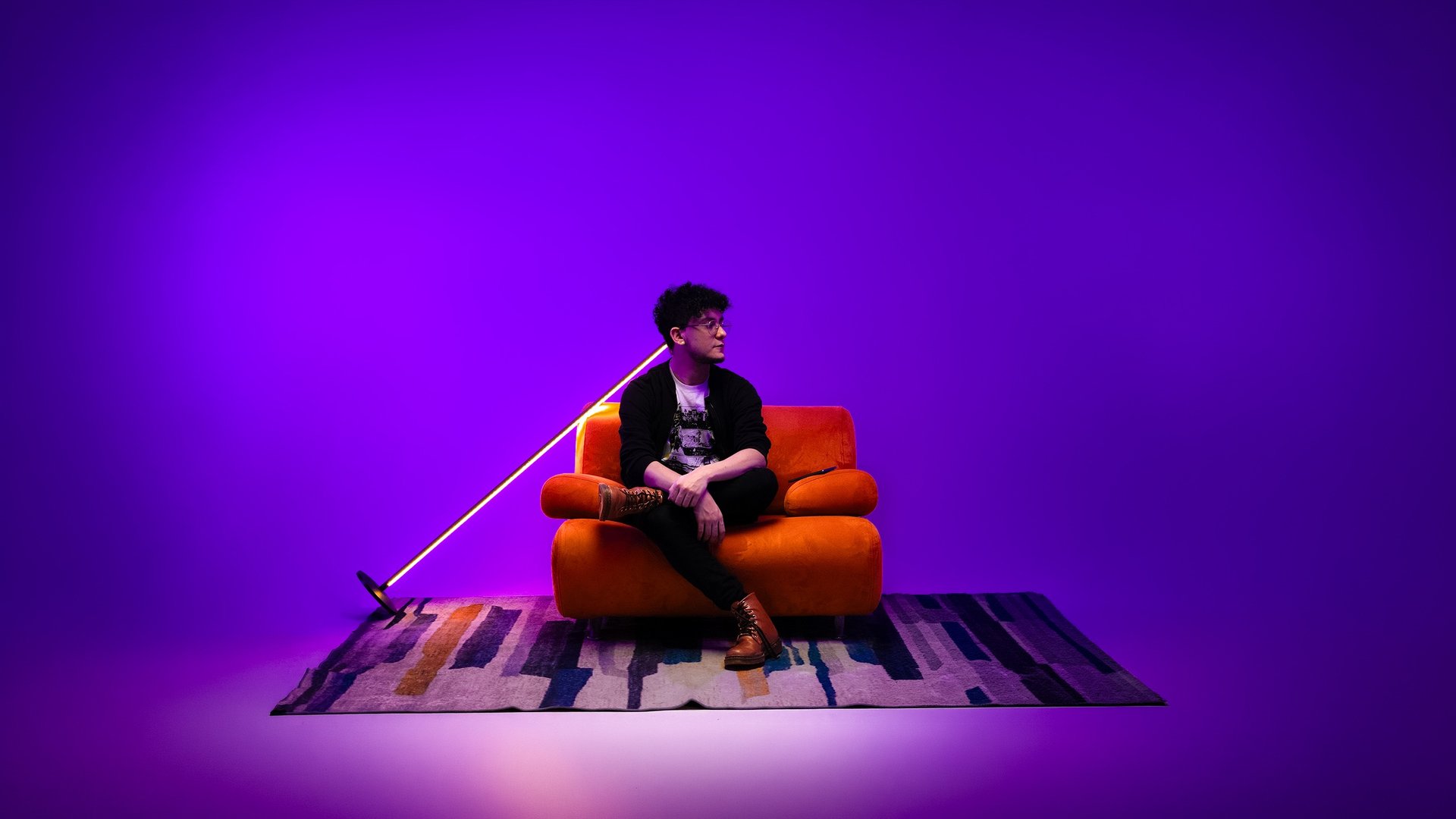 A man wearing glasses and a denim jacket