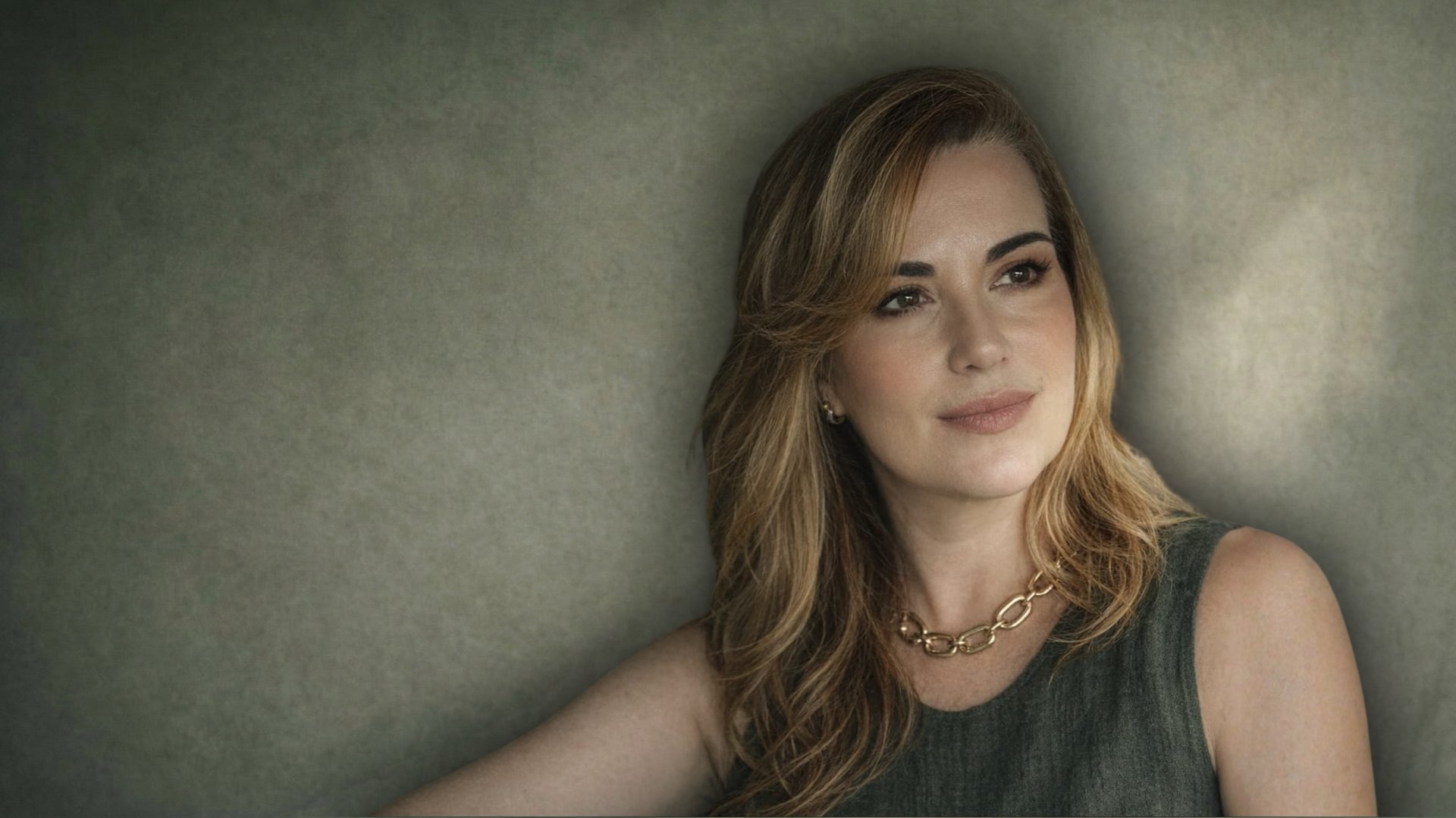 person in black long sleeve shirt holding babys feet