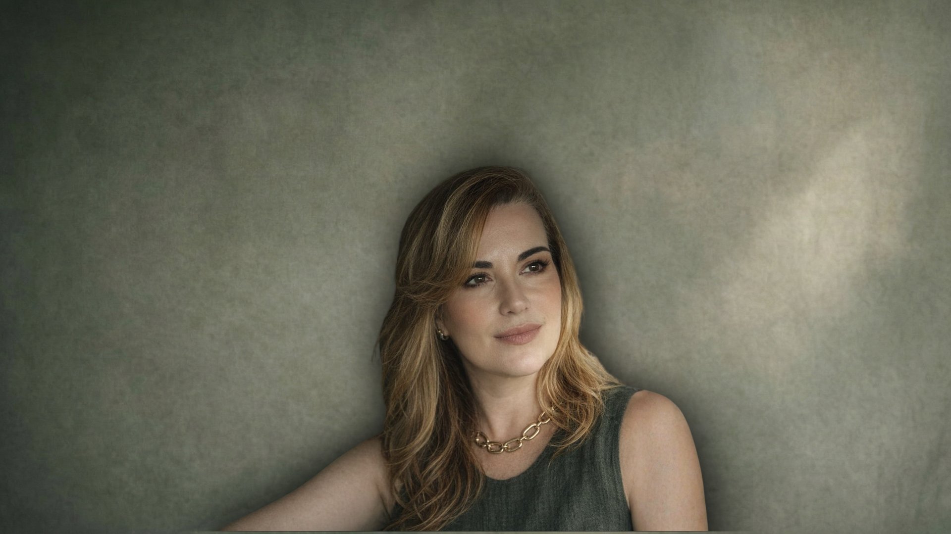 person in black long sleeve shirt holding babys feet