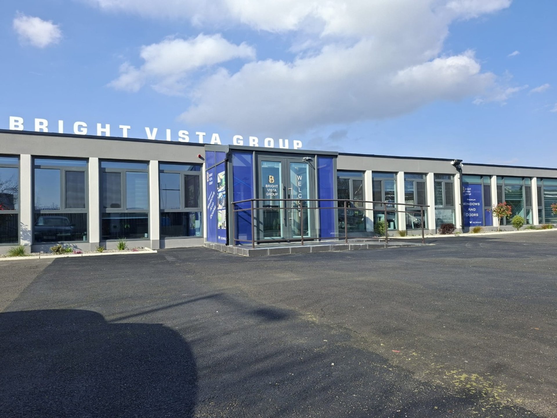an abstract photo of a curved building with a blue sky in the background
