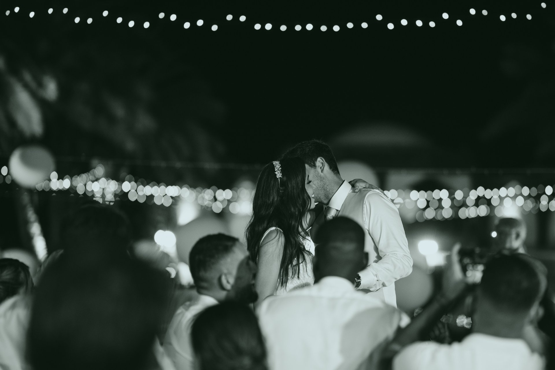man and woman kissing while standing on stairs