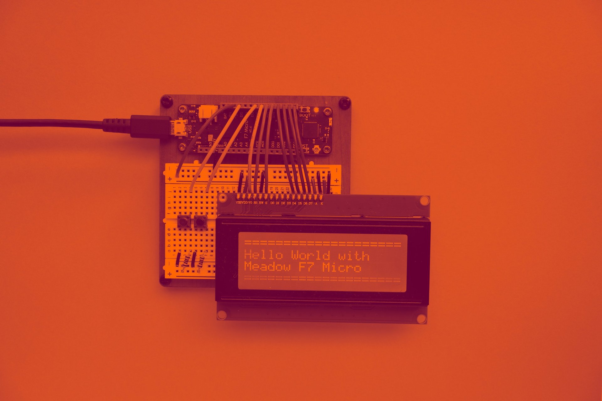 an electronic device with a blue screen on a yellow surface