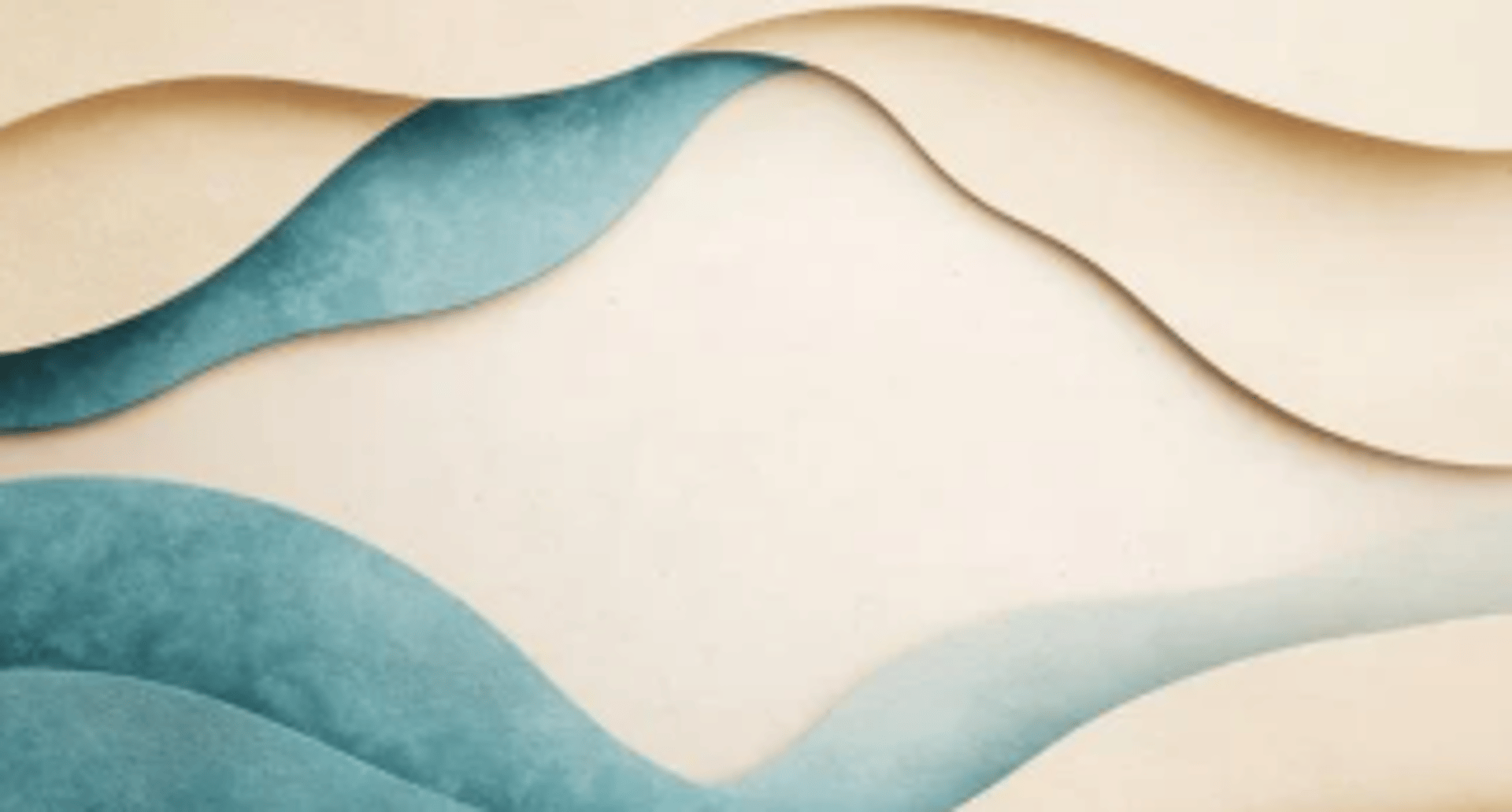 A collection of smooth, varied stones on sand