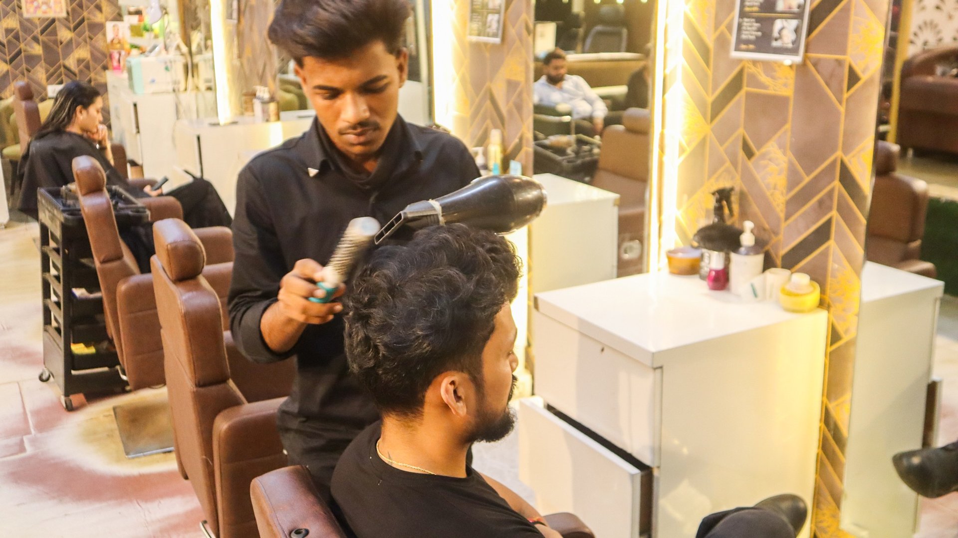 a woman getting her nails done at a nail salon