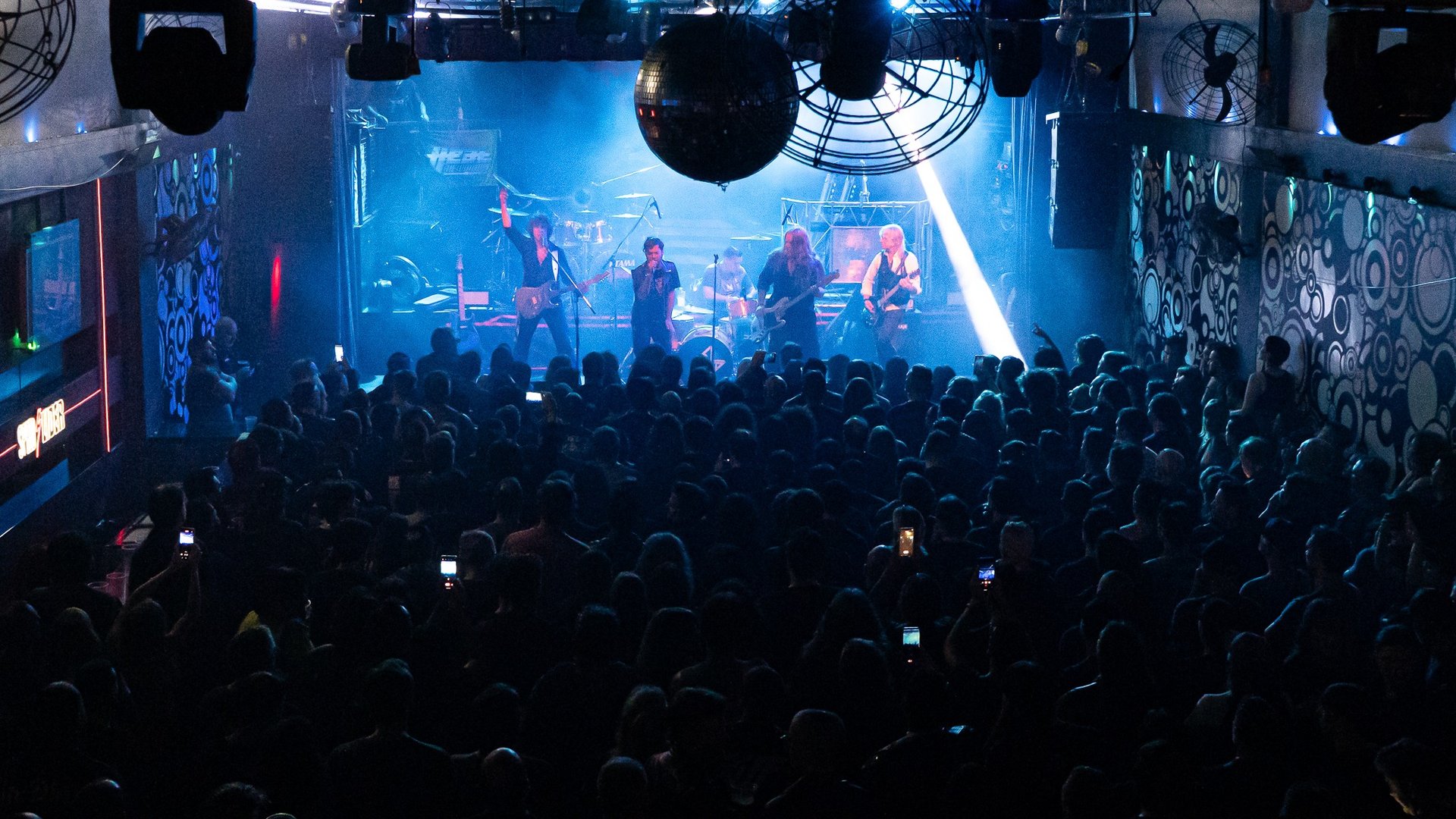an abstract photo of a curved building with a blue sky in the background