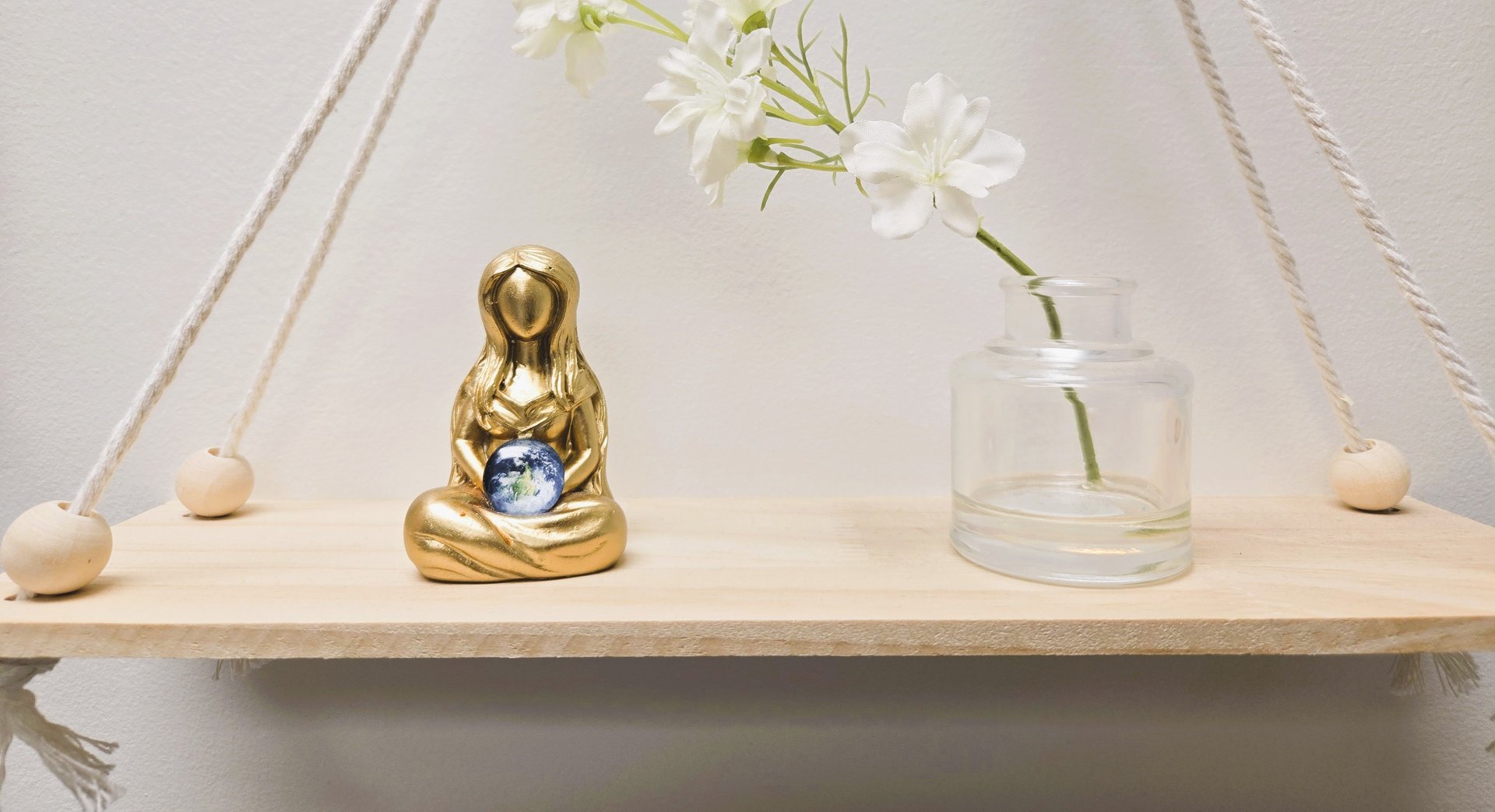 a black and white photo of a cat sitting on a window sill