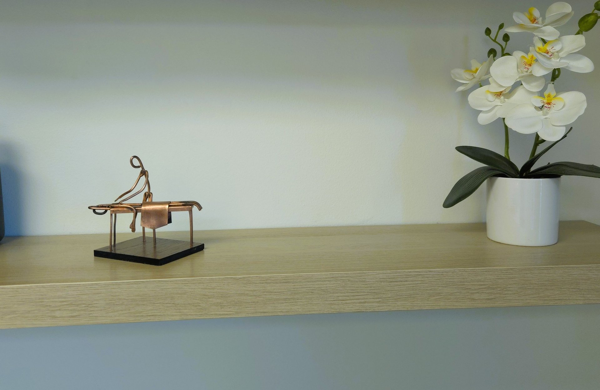 a black and white photo of a cat sitting on a window sill