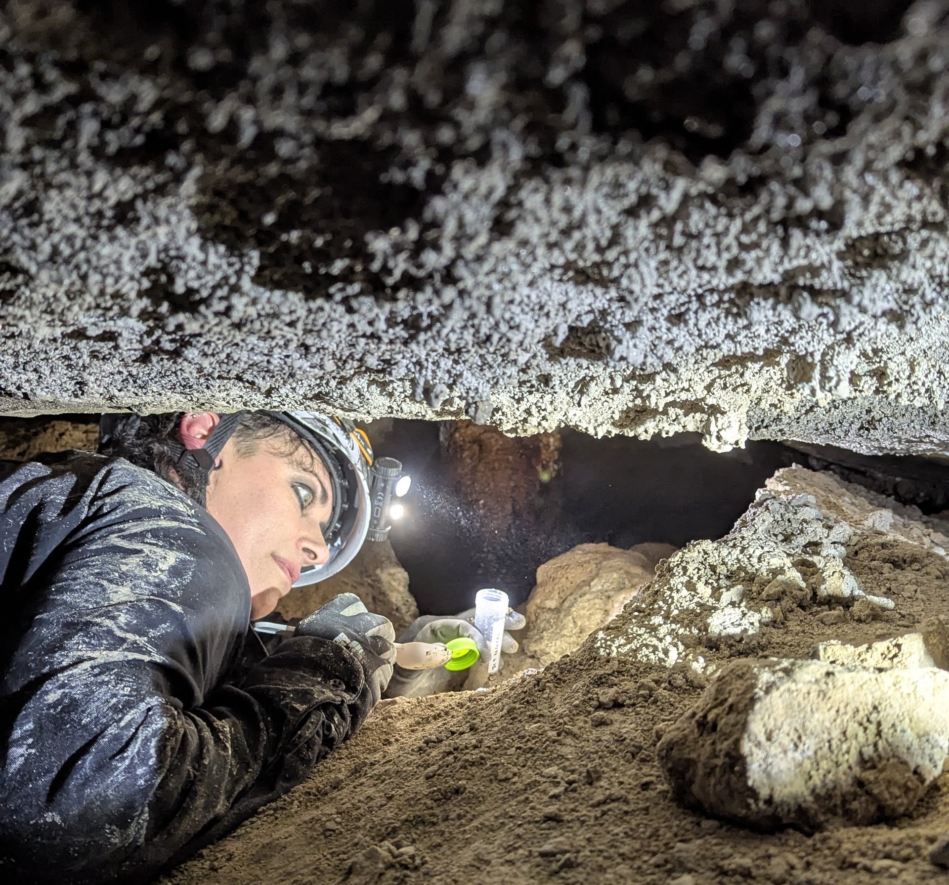 woman standing inside cave