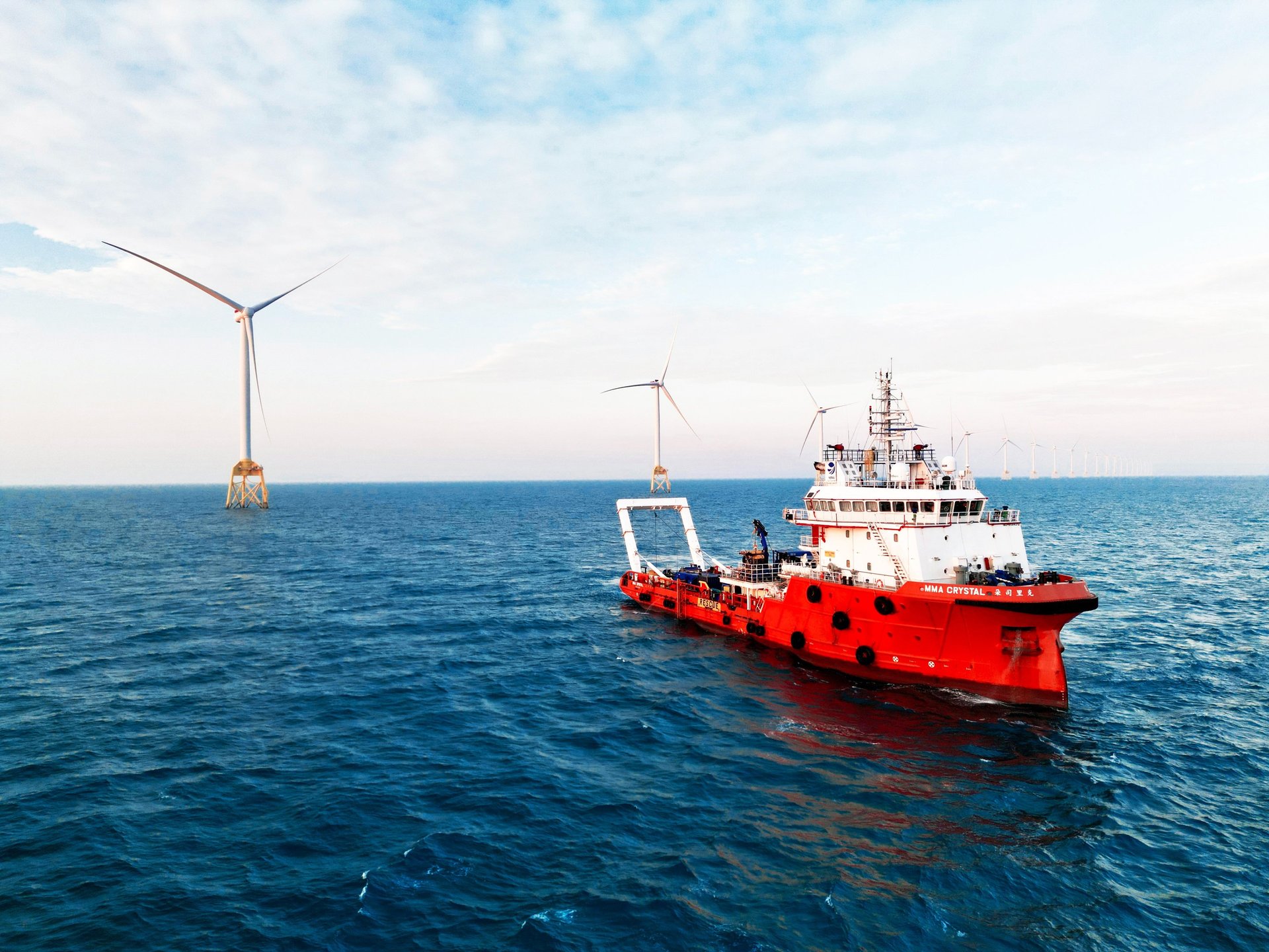 a group of wind turbines in the ocean