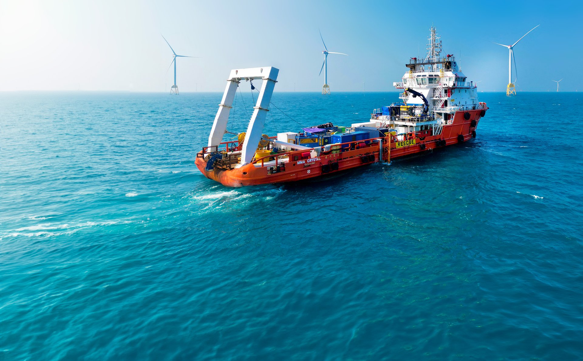 a group of wind turbines in the ocean
