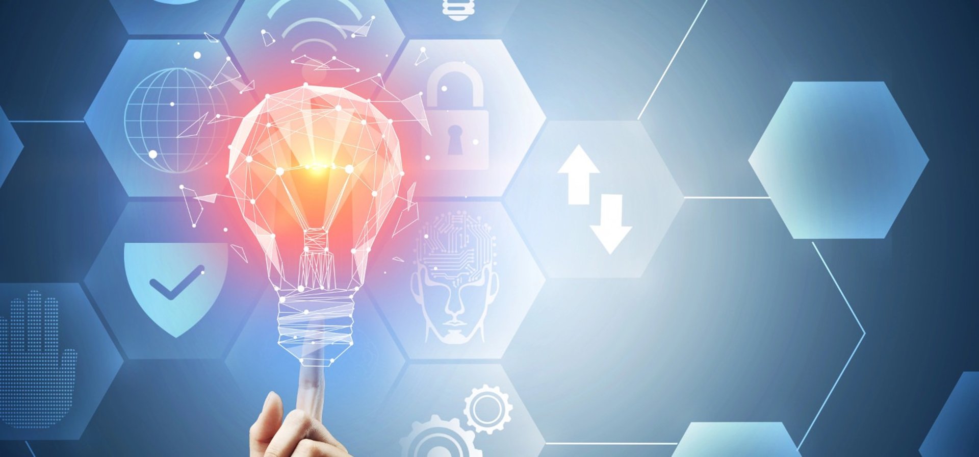 A hand holds a light bulb with symbols surrounding it