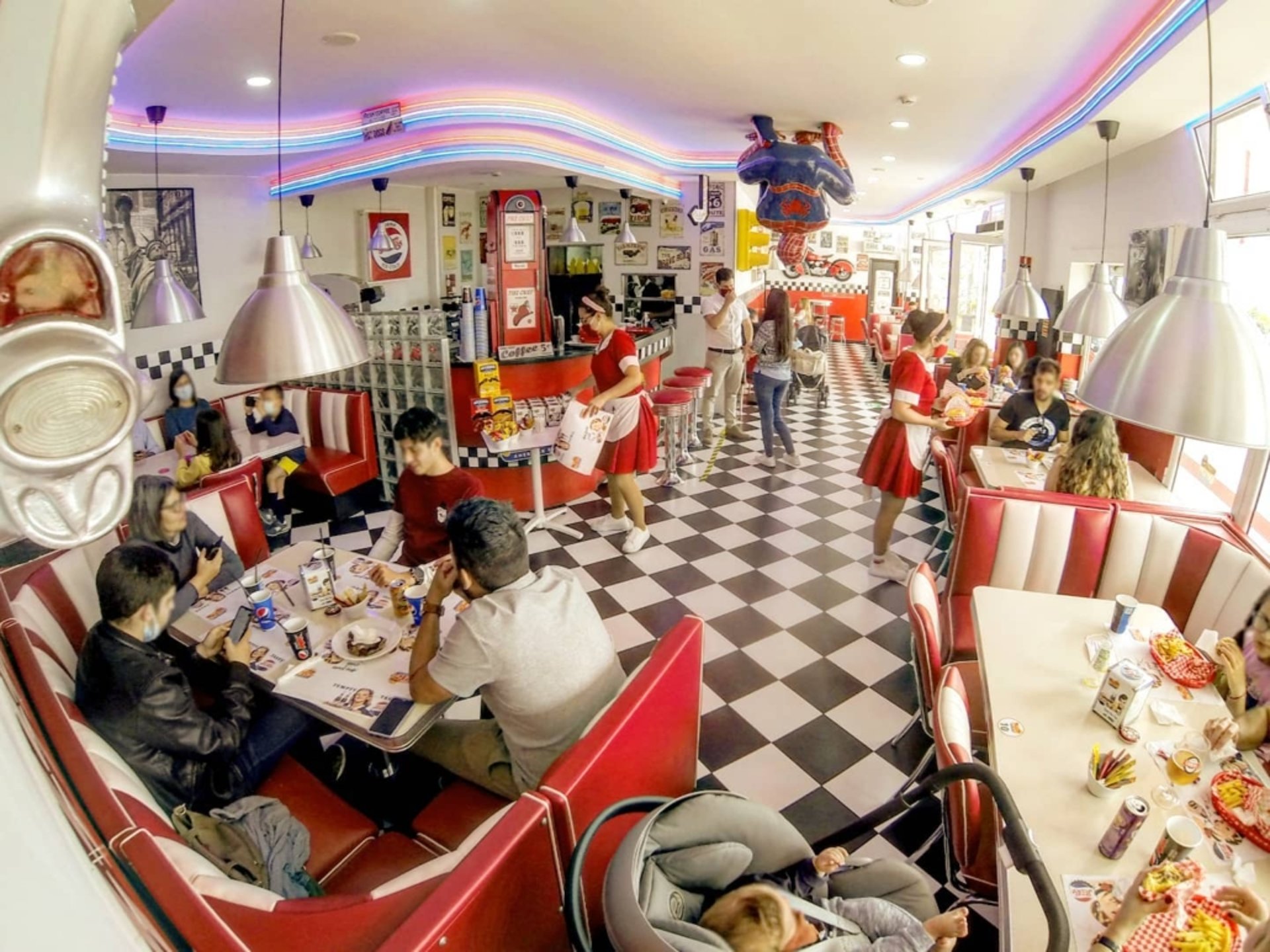 Someone is taking a slice of pepperoni pizza.