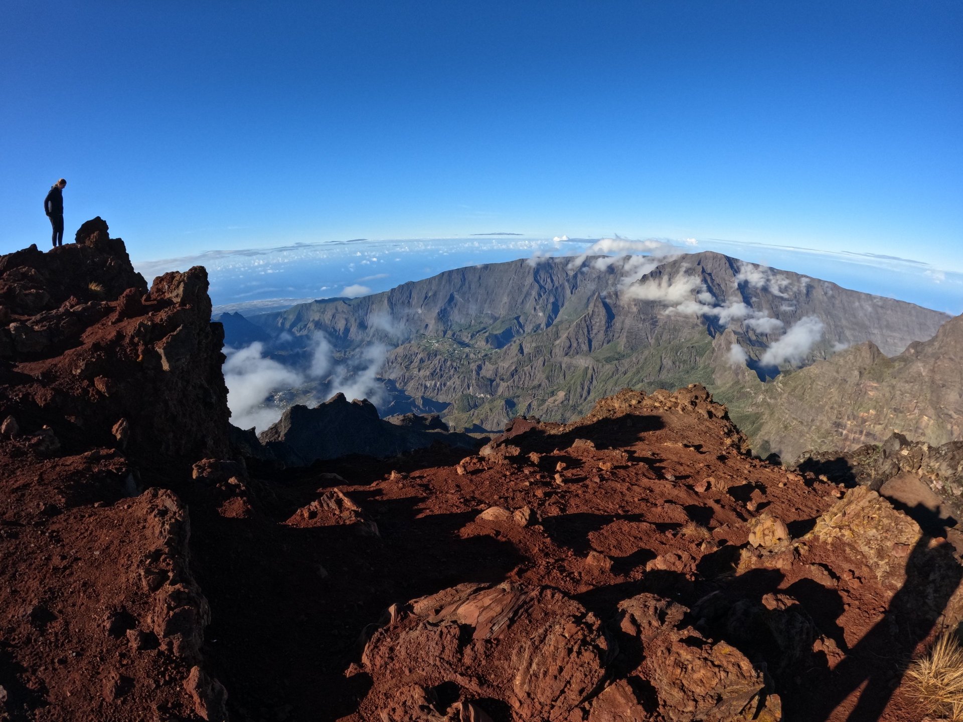 woman wearing yellow long-sleeved dress under white clouds and blue sky during daytime