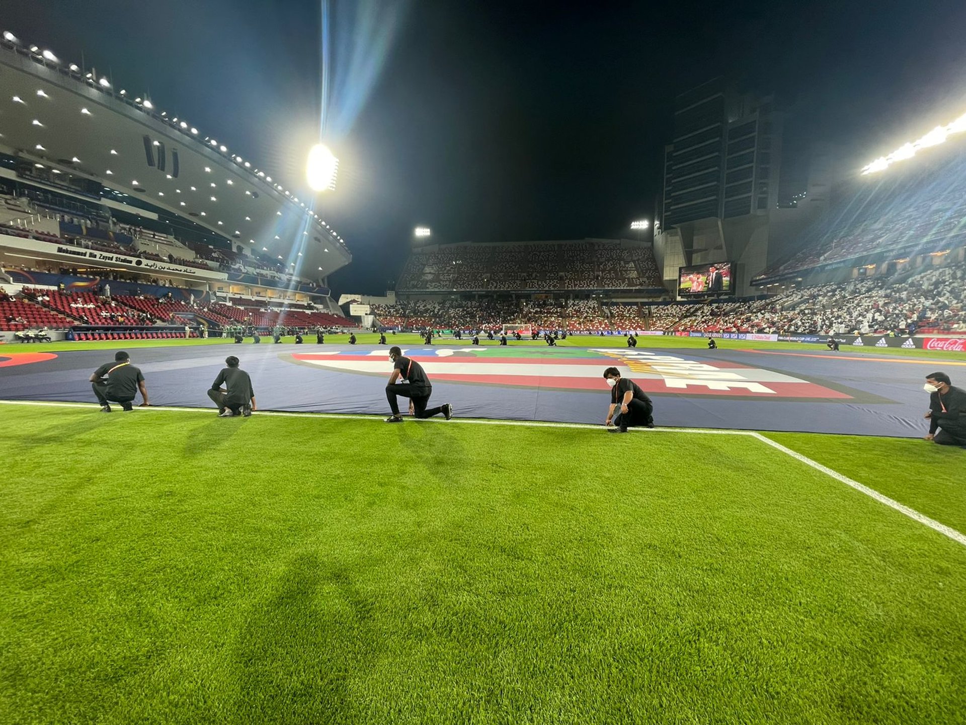 person standing in stage in front of people