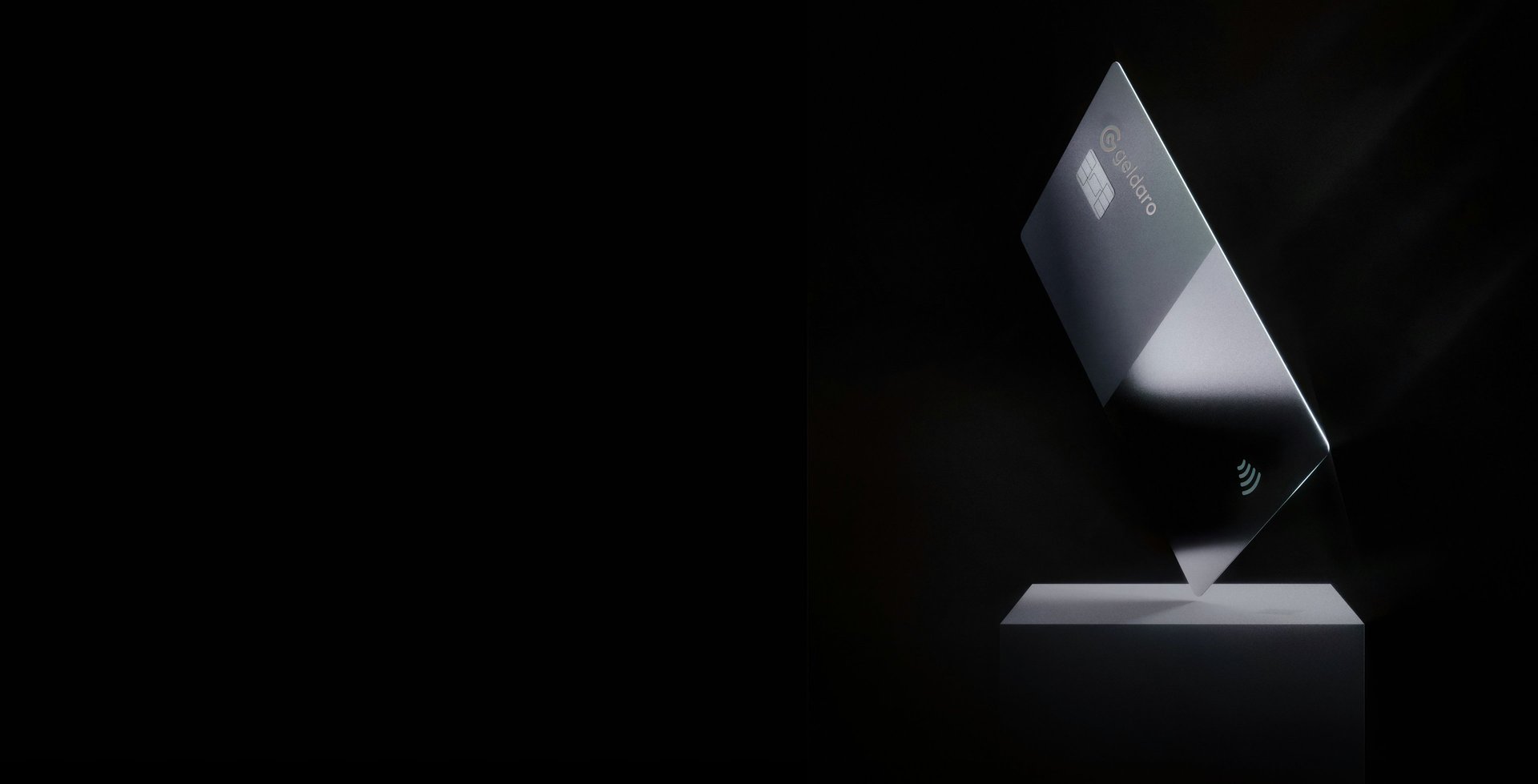 a silver credit card on top of a white stand