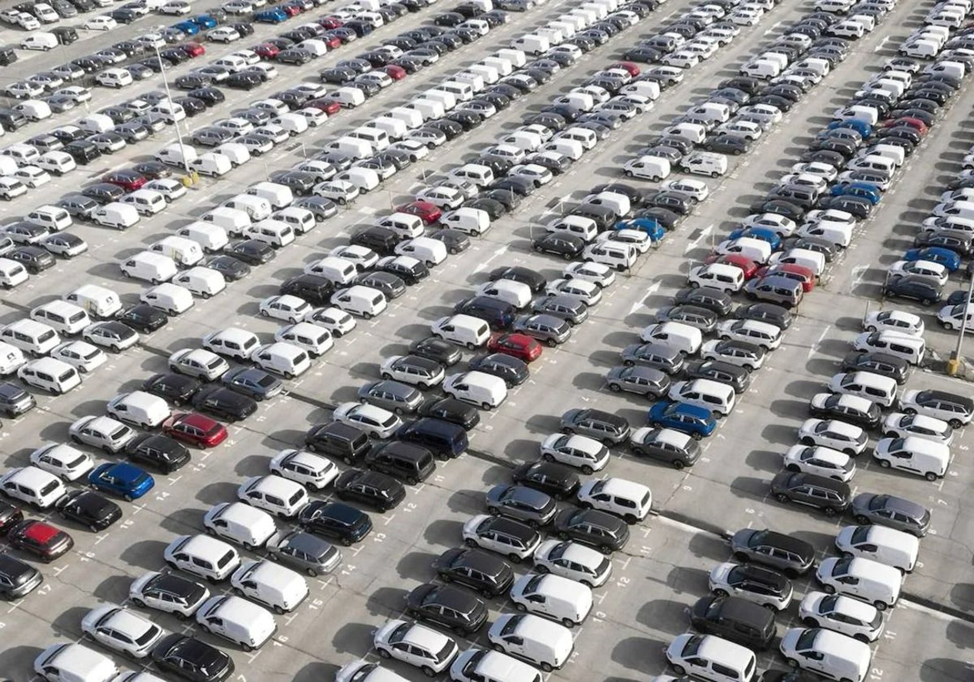 a black and white photo of trucks parked in a lot