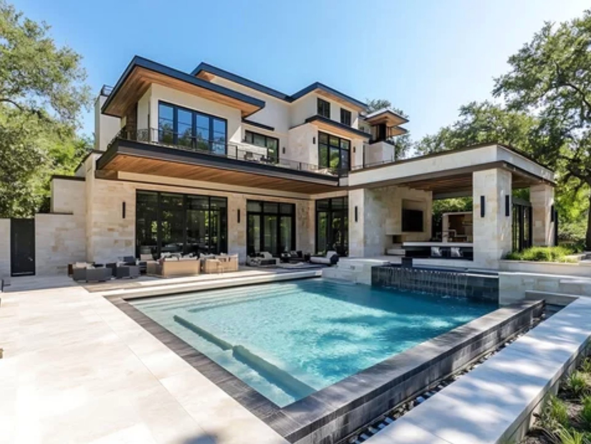 A gorgeous modern home exterior with pool