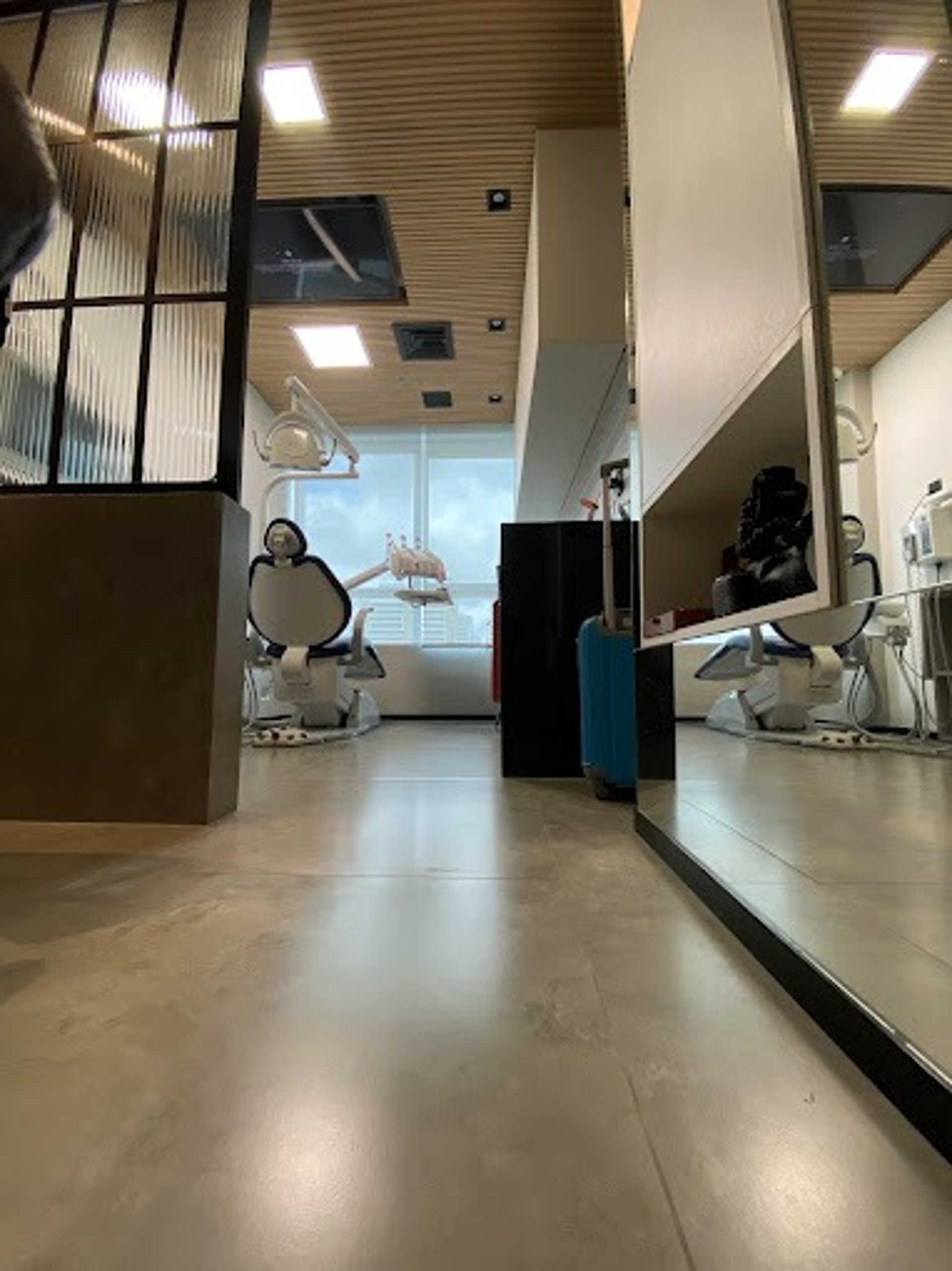 a dental room with a blue chair and dental equipment