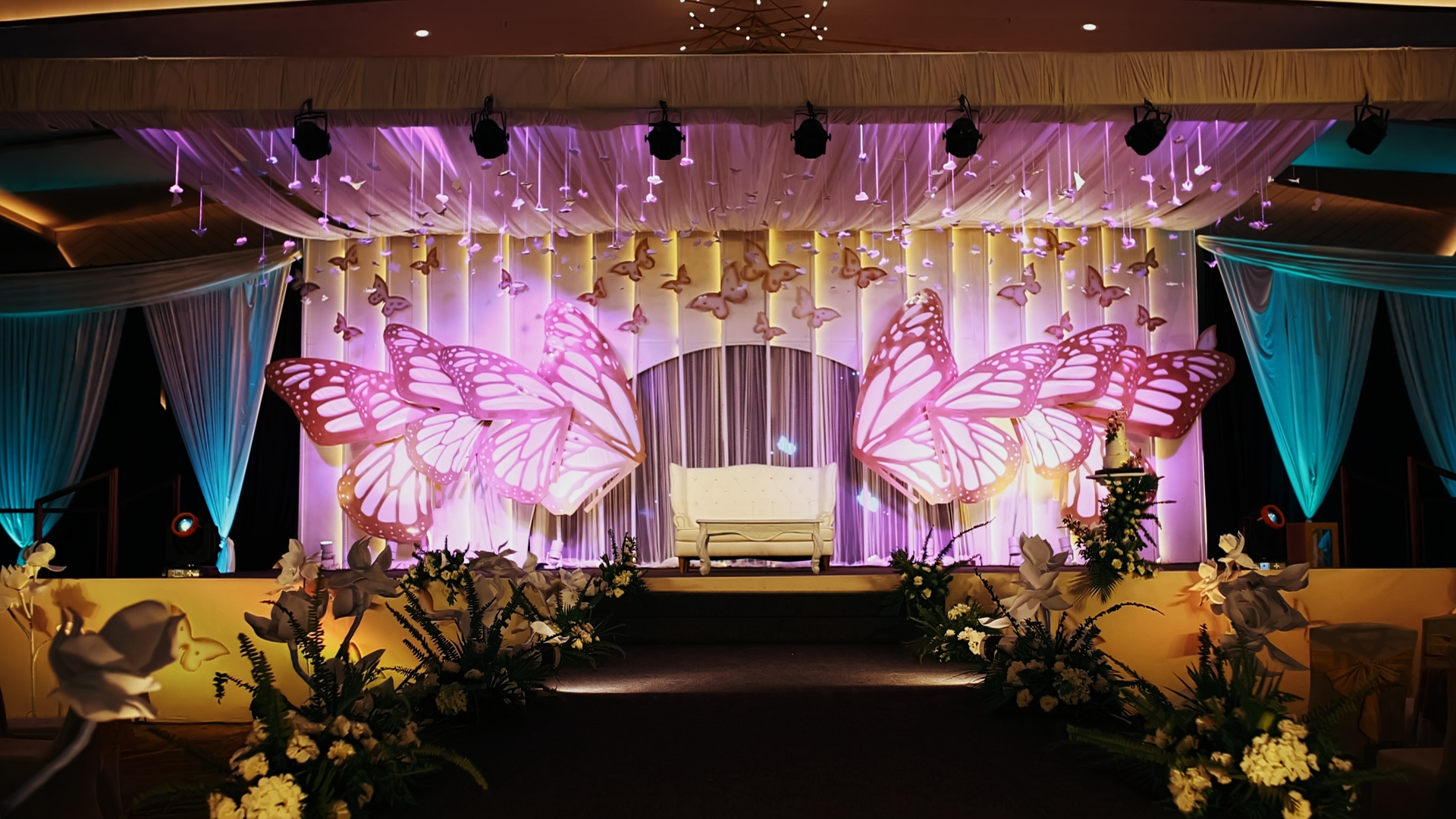 A beautiful stage is decorated for an event.