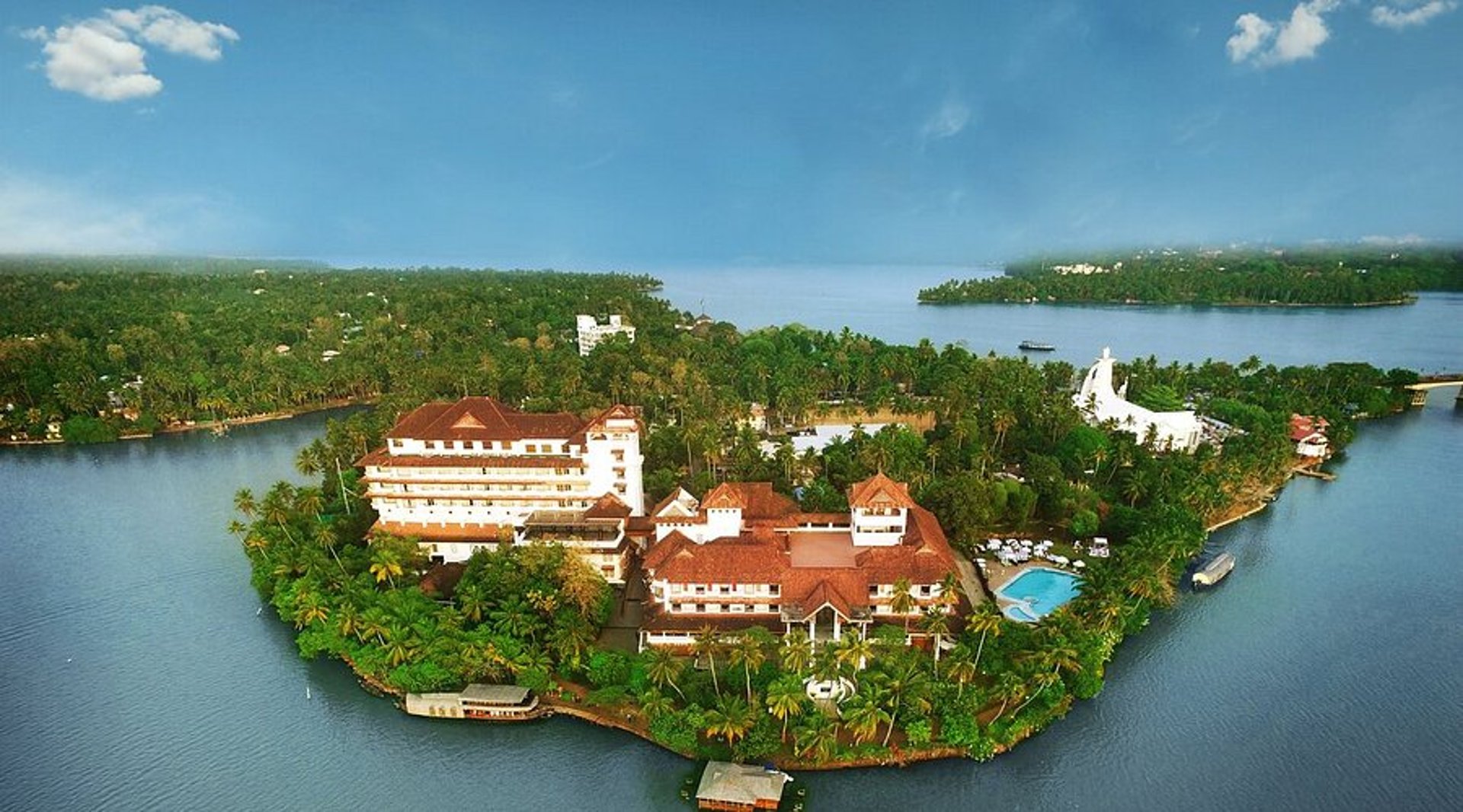 a white building with a bunch of flowers growing on the side of it