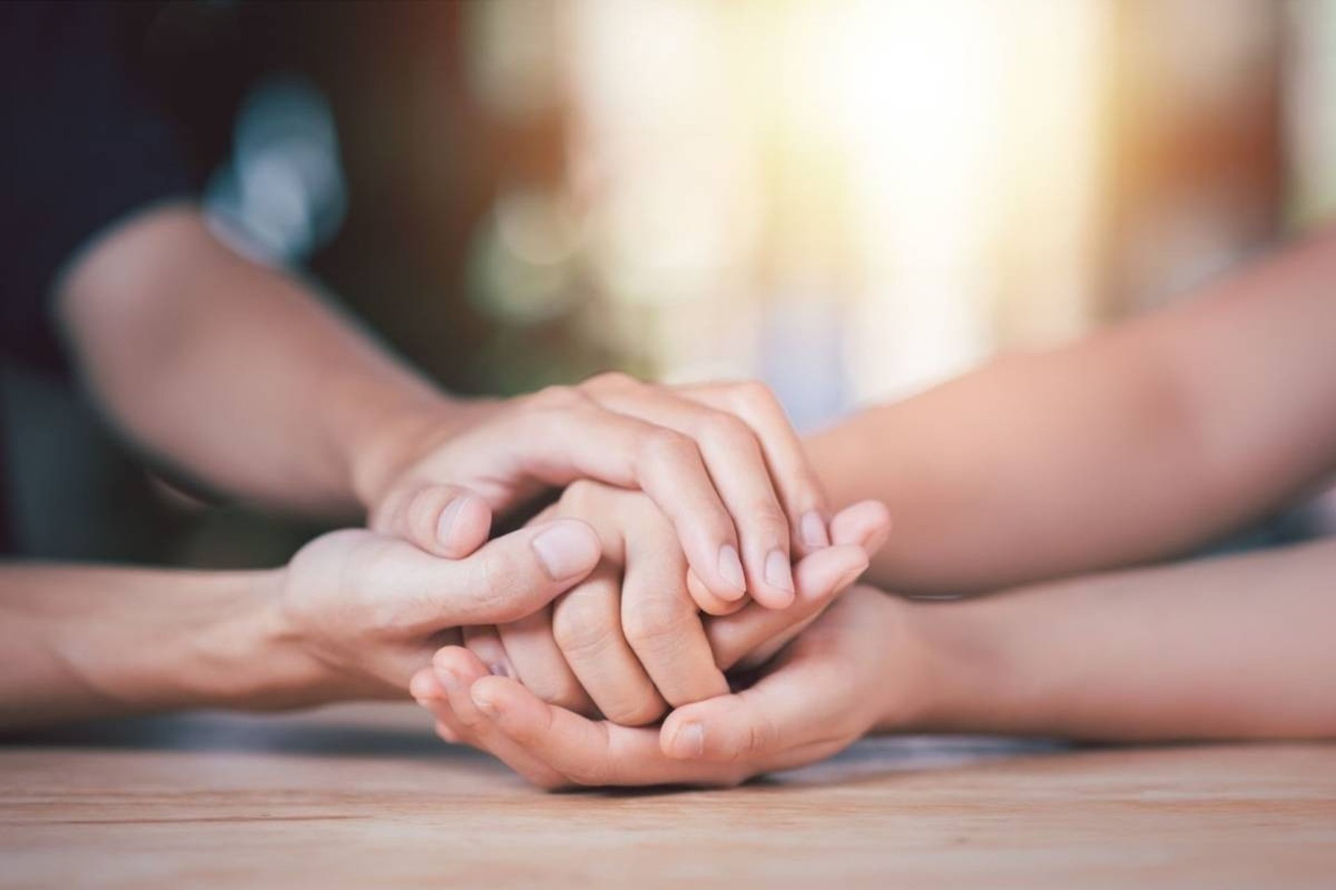 flat lay photography of man and woman holding hands together