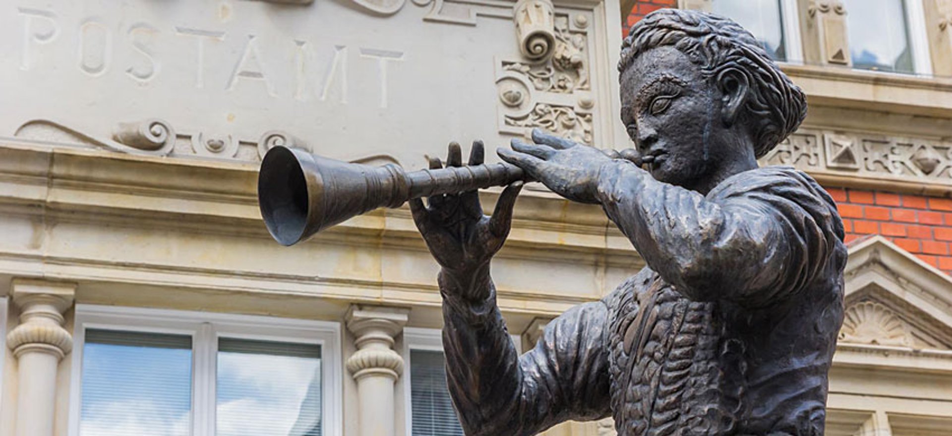a cat laying on top of another cat in a car