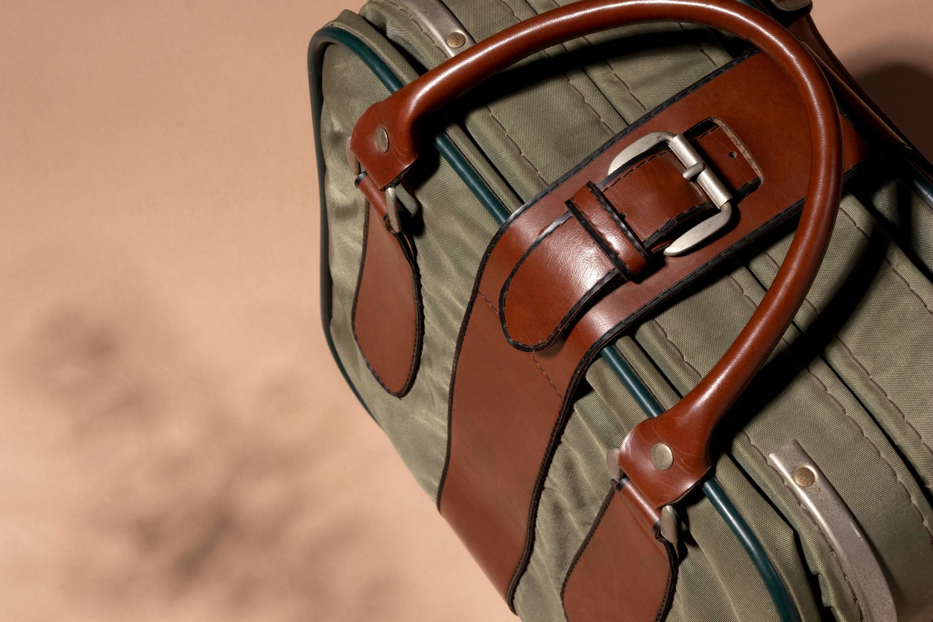black leather sling bag on brown wooden round table