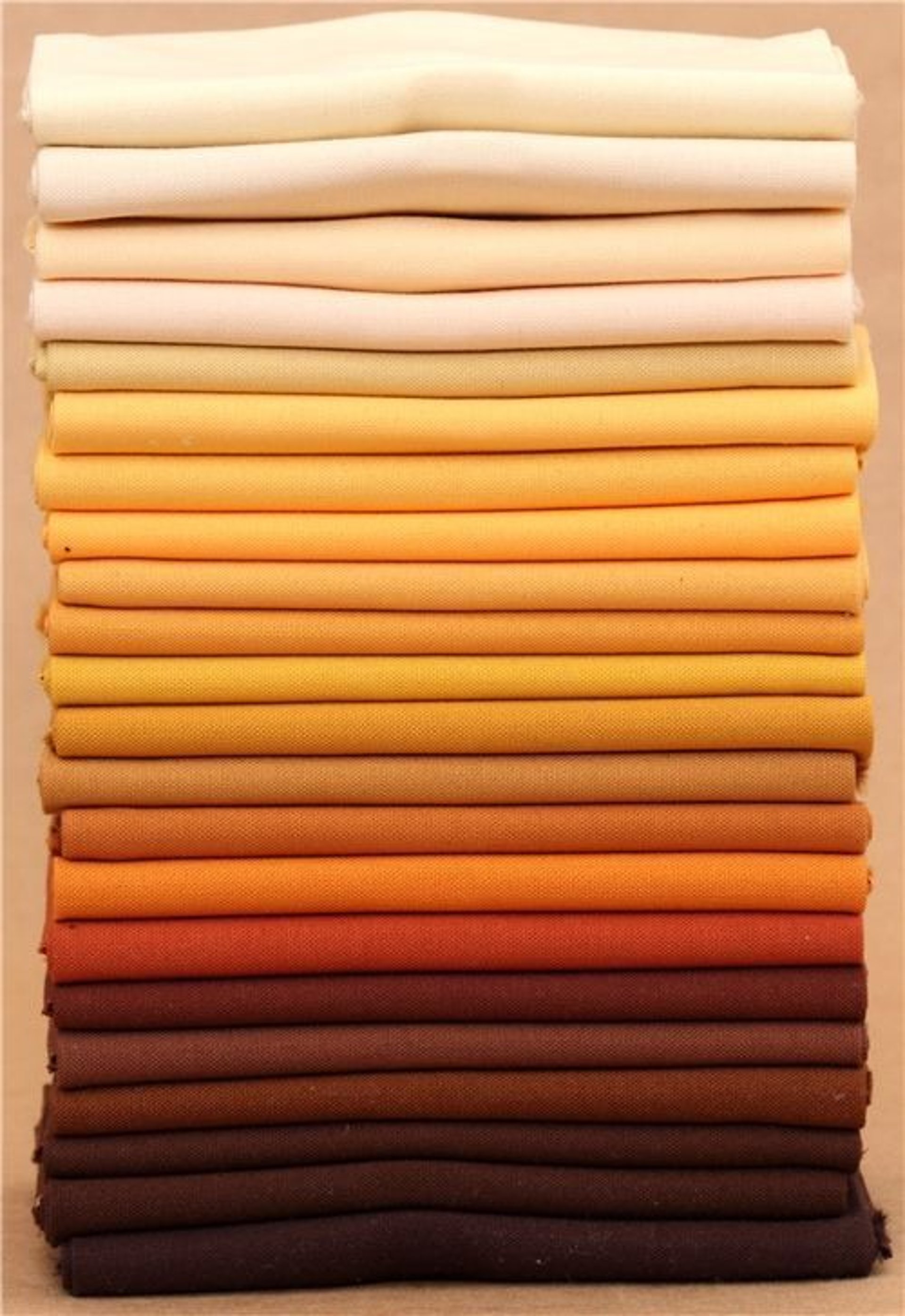 a pile of multicolored scarves sitting on top of a table