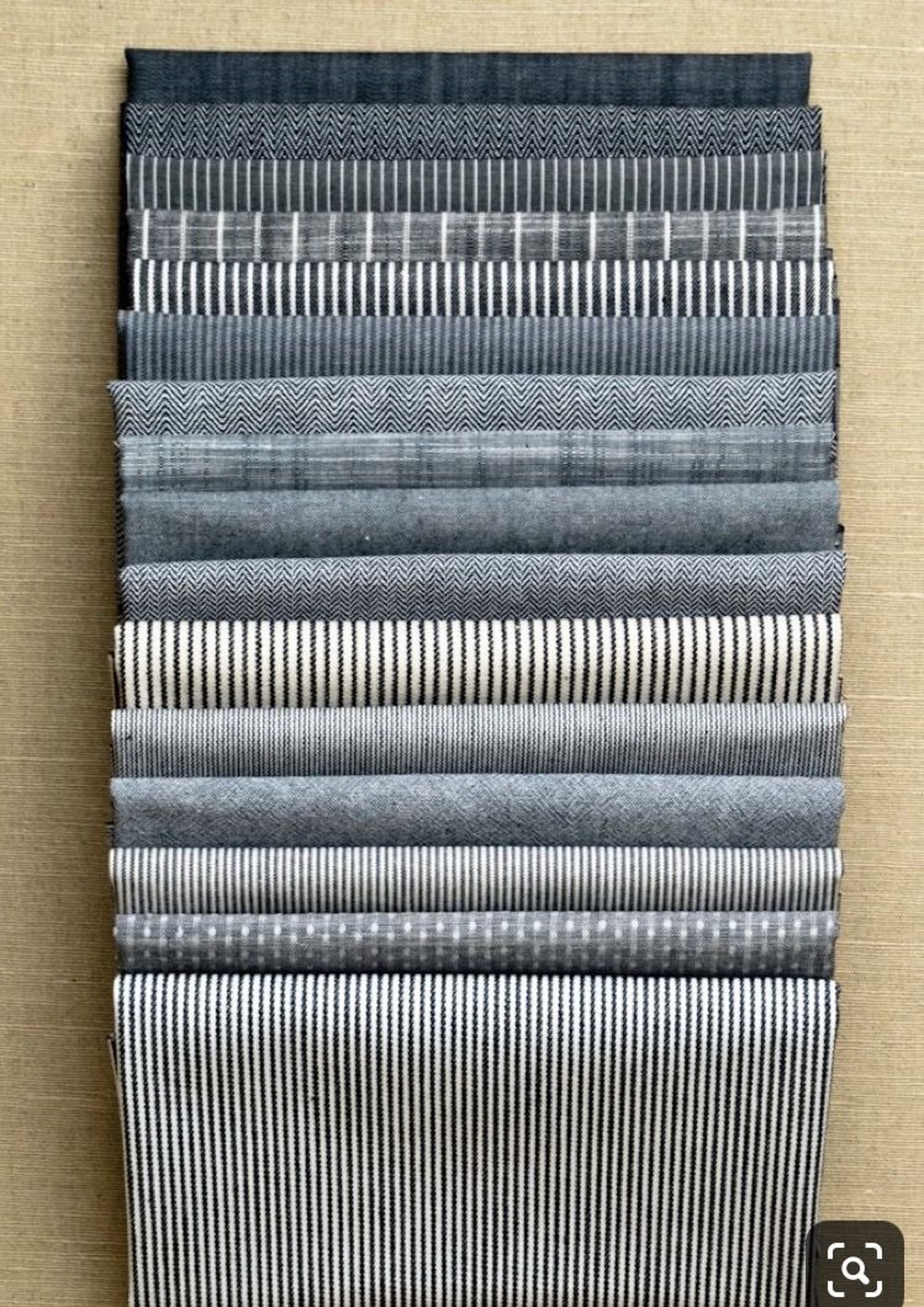 a bunch of different colored yarns hanging on a wall