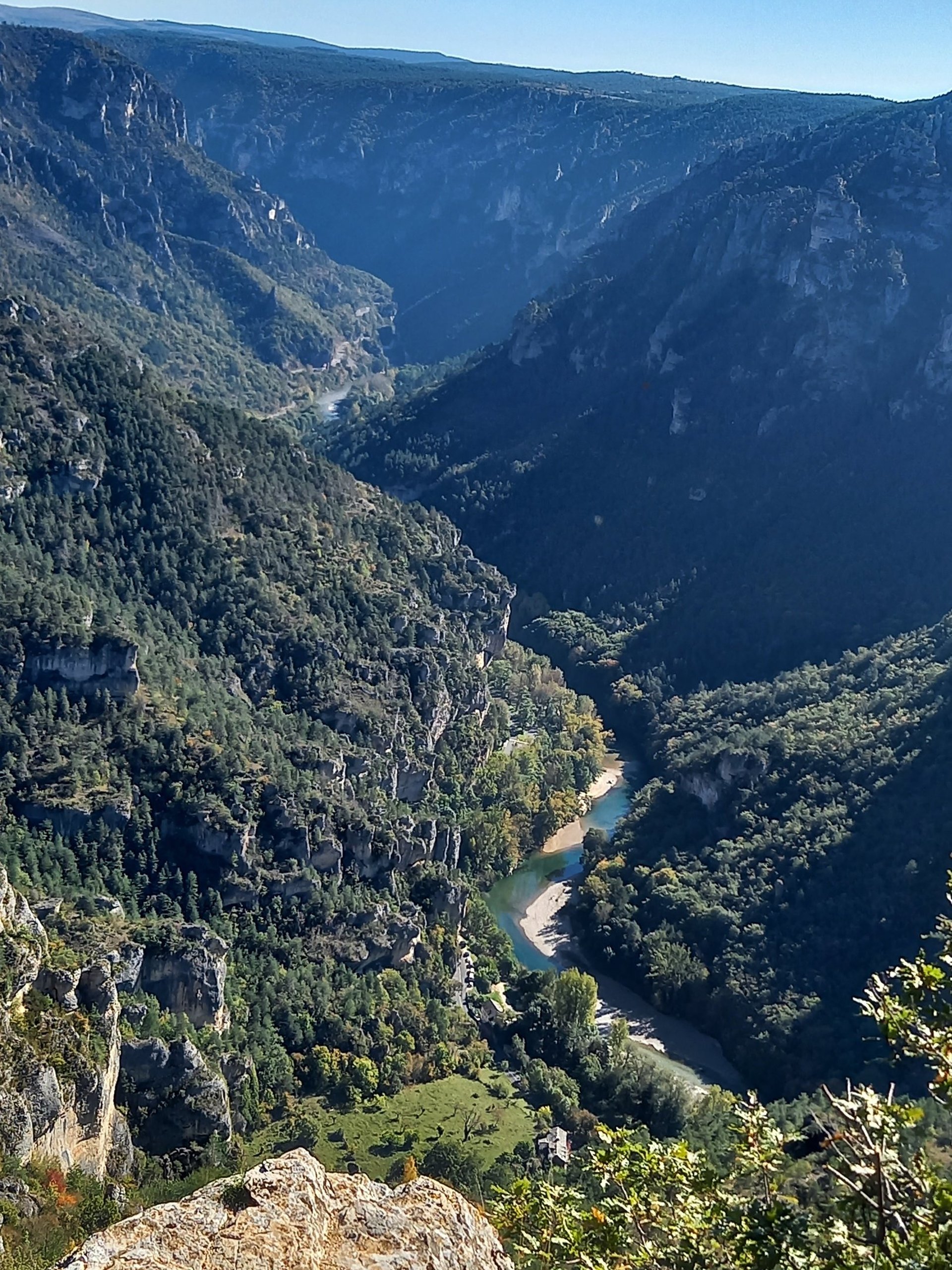 an abstract photo of a curved building with a blue sky in the background