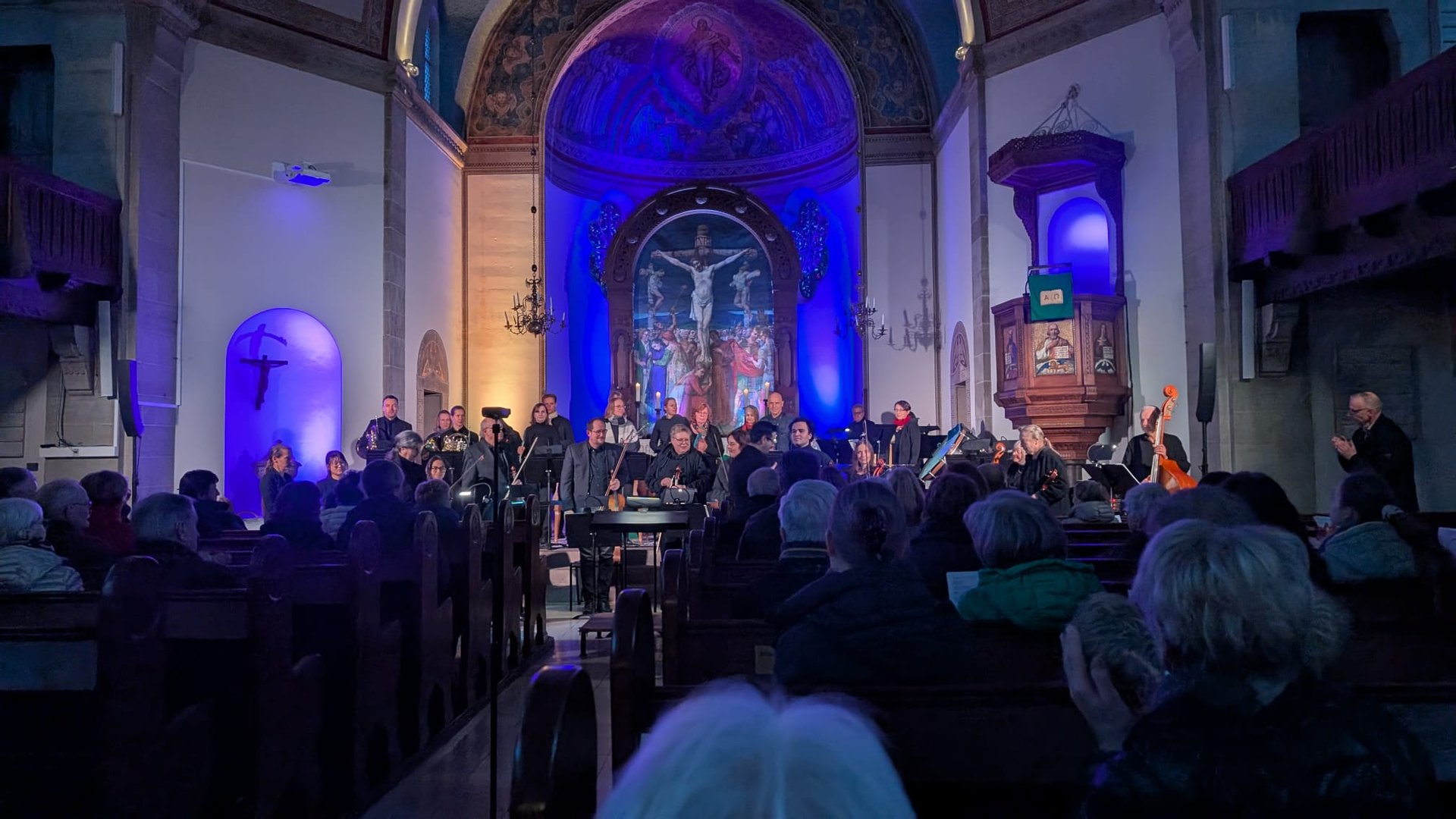 music group performing on stage with empty audience seats