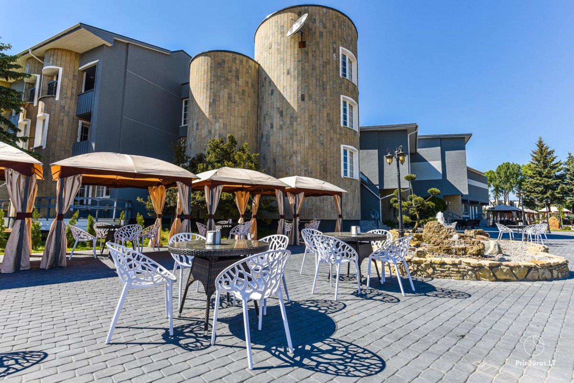 an abstract photo of a curved building with a blue sky in the background