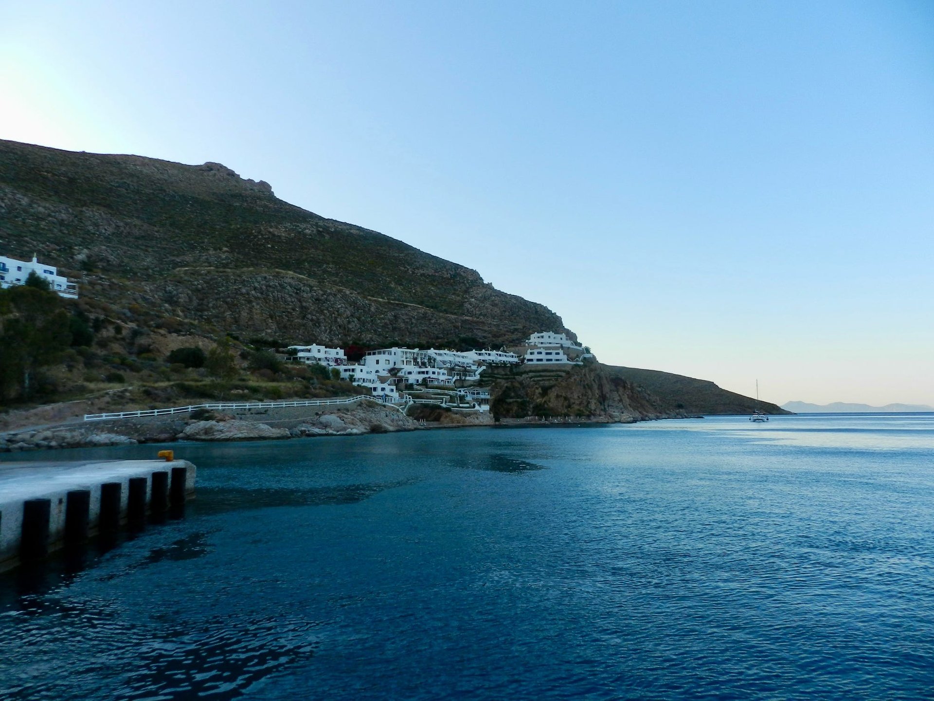 woman wearing yellow long-sleeved dress under white clouds and blue sky during daytime